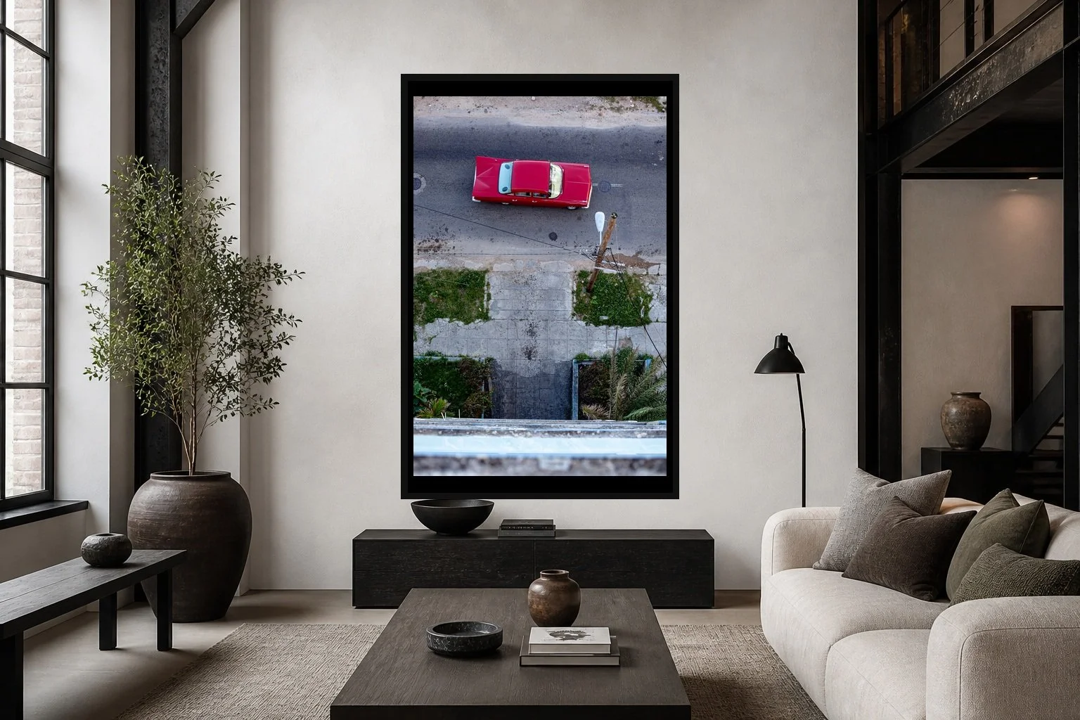 59 Impala displayed in a black frame within a modern collector's loft with white plaster, blackened steel, textured fabrics, and a clear central wall