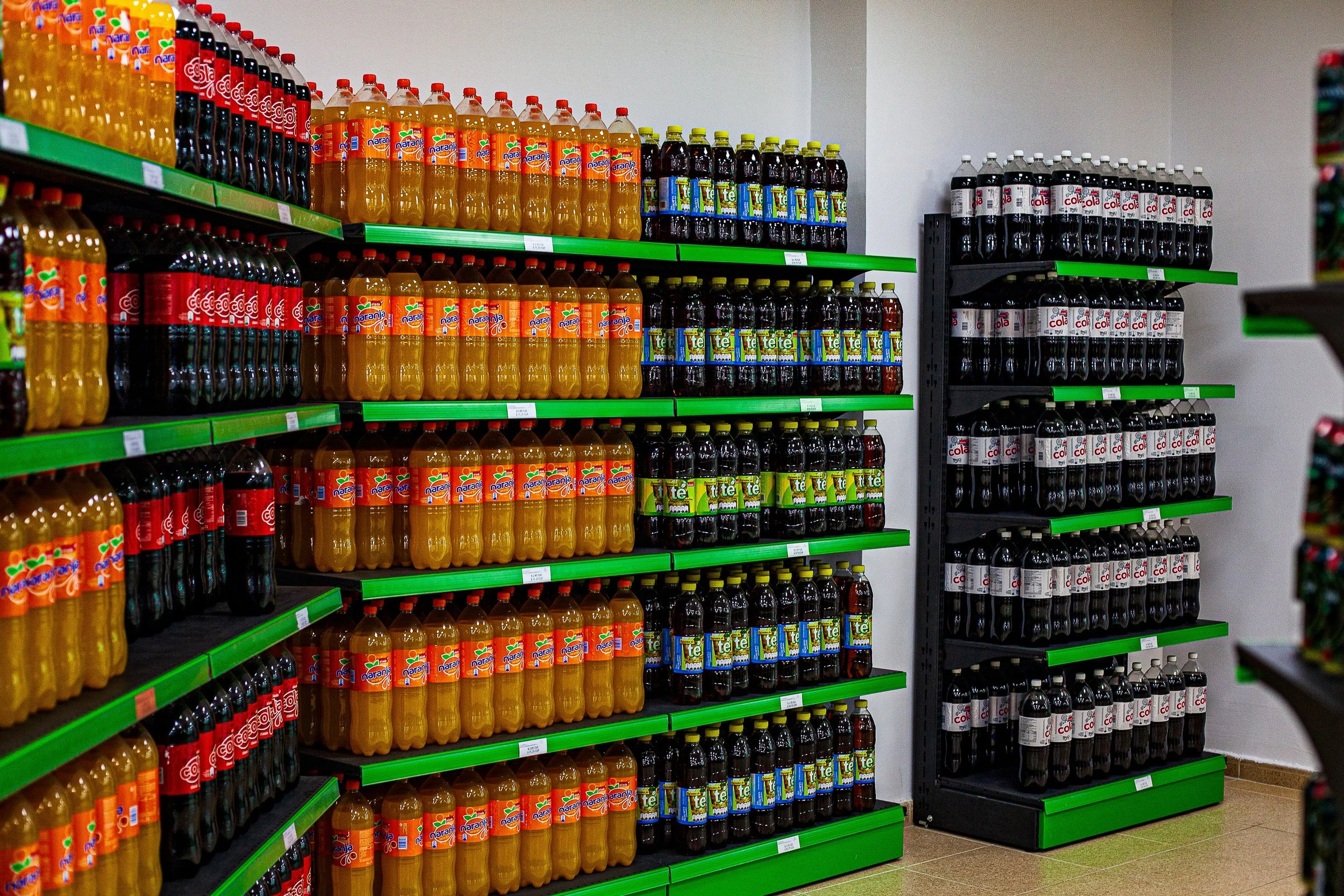 Complete uncropped artwork for Bottled Color, showing rows of brightly colored bottled drinks fill green retail shelves