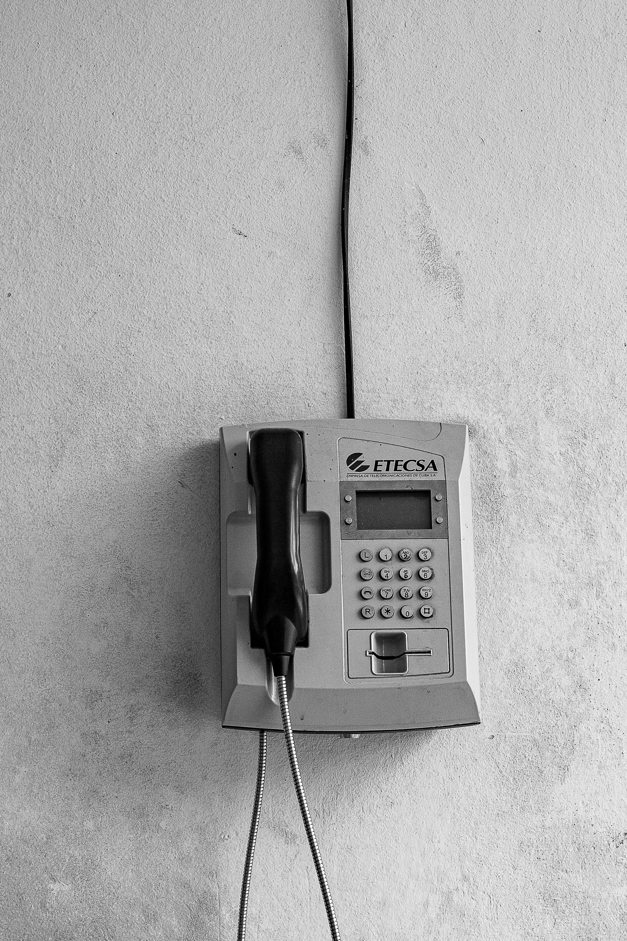 Detail crop from Call Box, emphasizing the loose cord and wall seam give the minimal composition a quiet human trace