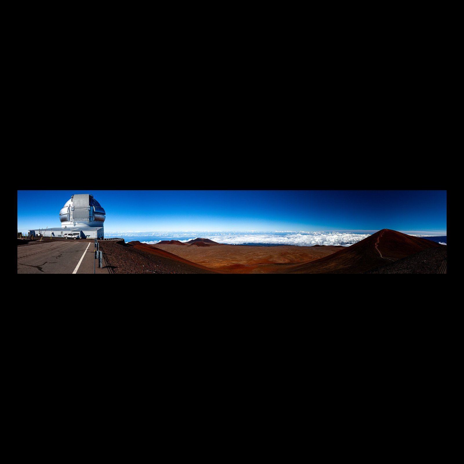 Full-frame black presentation thumbnail of Summit Observatory, showing a wide observatory complex and red volcanic cones stretch above a white cloud layer