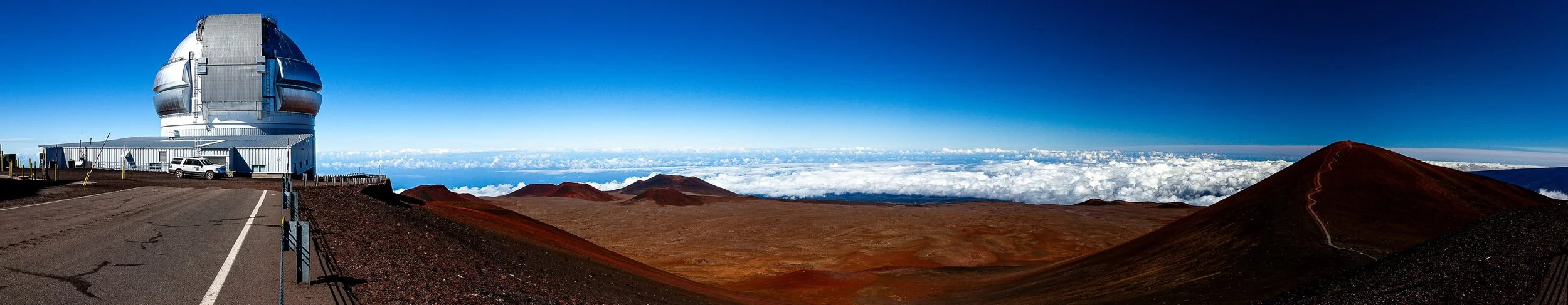 Complete uncropped artwork for Summit Observatory, showing a wide observatory complex and red volcanic cones stretch above a white cloud layer