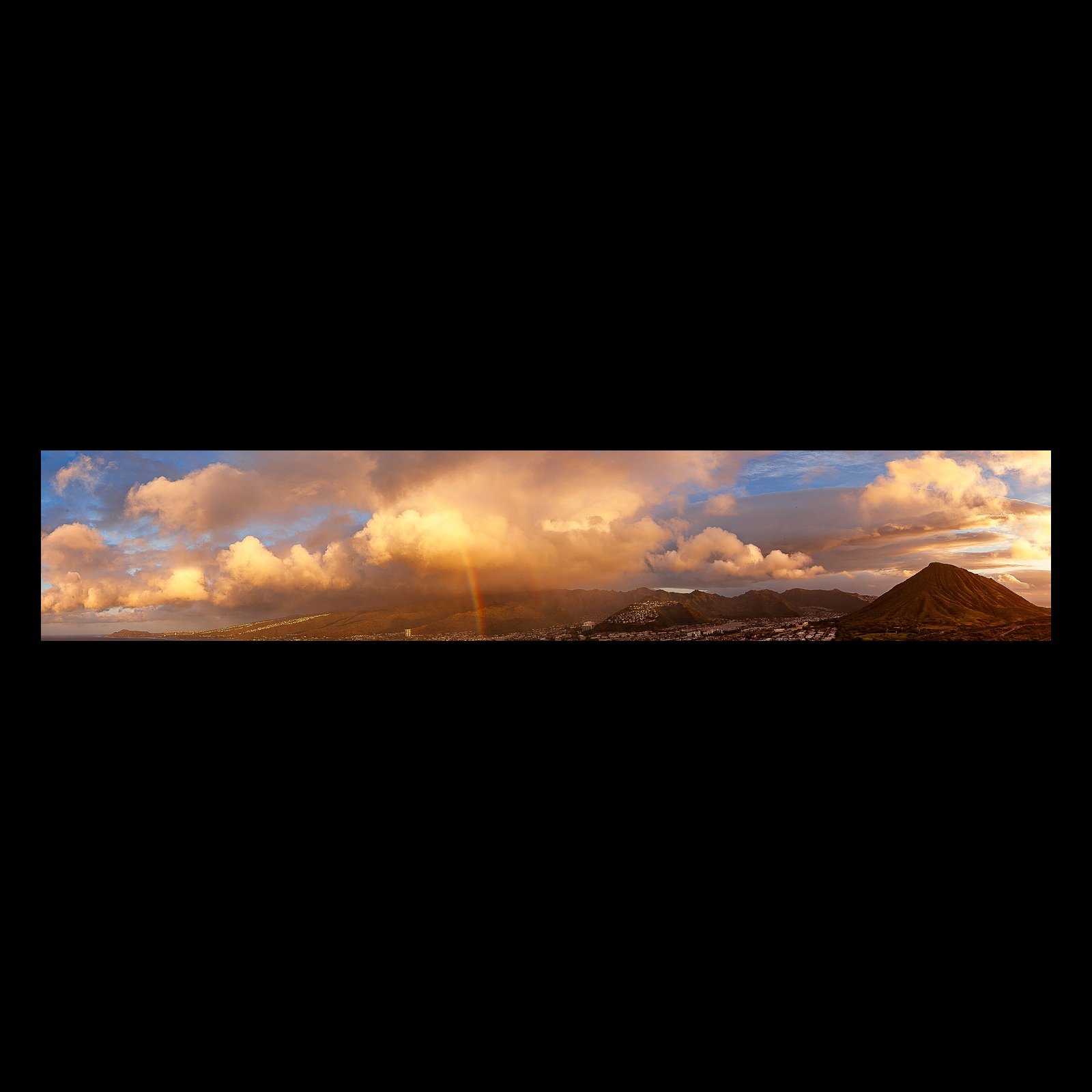 Full-frame black presentation thumbnail of Rain Over the Ridge, showing golden clouds and a narrow rain shaft sweep across a dark mountain ridge in a wide panorama