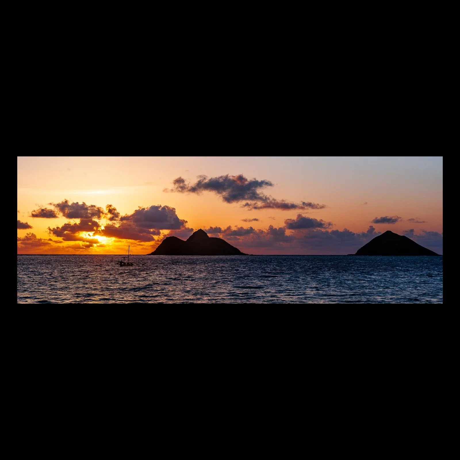 Full-frame black presentation thumbnail of Islands at Sunset, showing two dark islands sit beneath a warm sunset reflected across open water