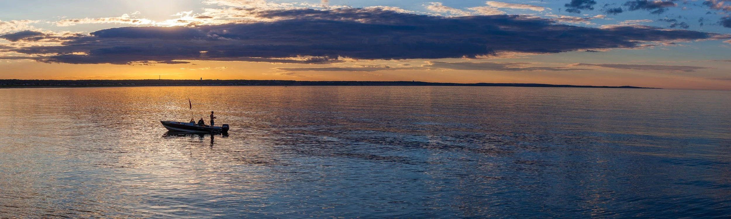 Detail crop from Boat on Still Water, emphasizing distant shorelines and cloud bands become clearer around the boat's dark silhouette
