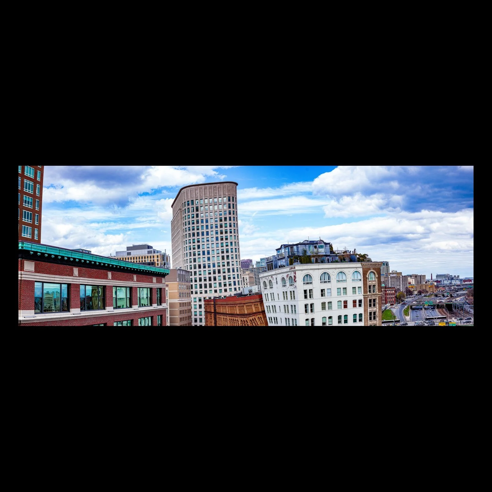 Full-frame black presentation thumbnail of City Layers, showing old masonry buildings, modern towers, and blue sky overlap in a broad urban panorama