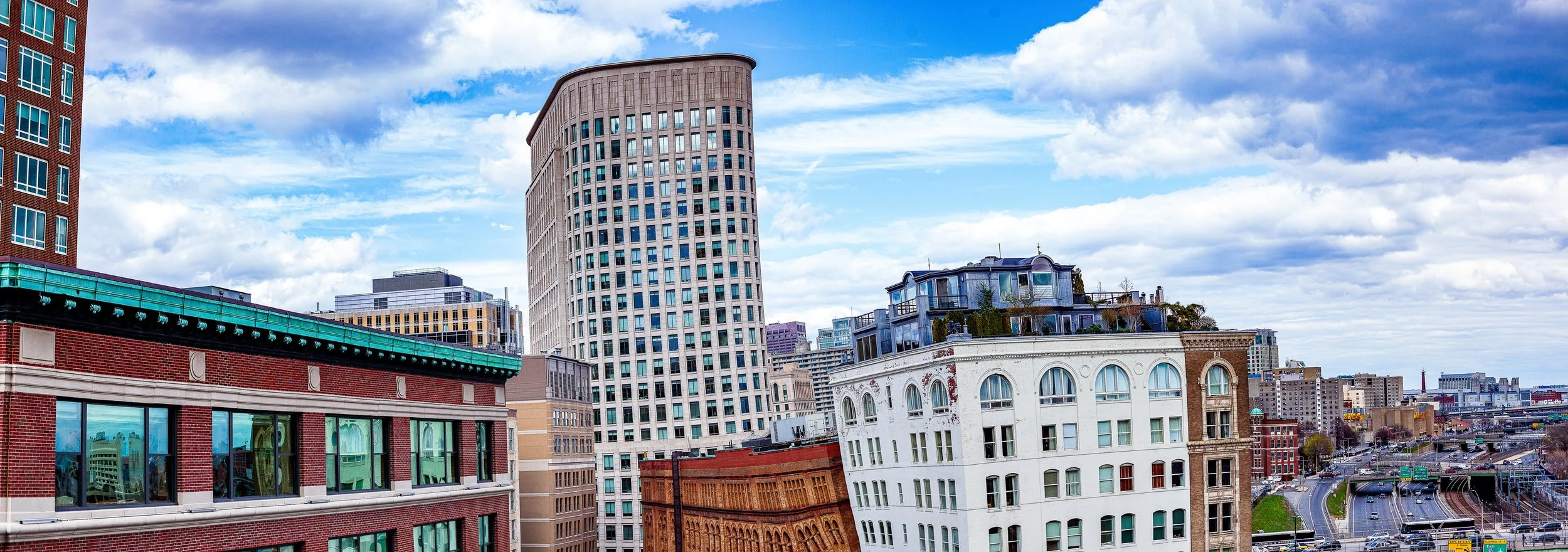 Complete uncropped artwork for City Layers, showing old masonry buildings, modern towers, and blue sky overlap in a broad urban panorama