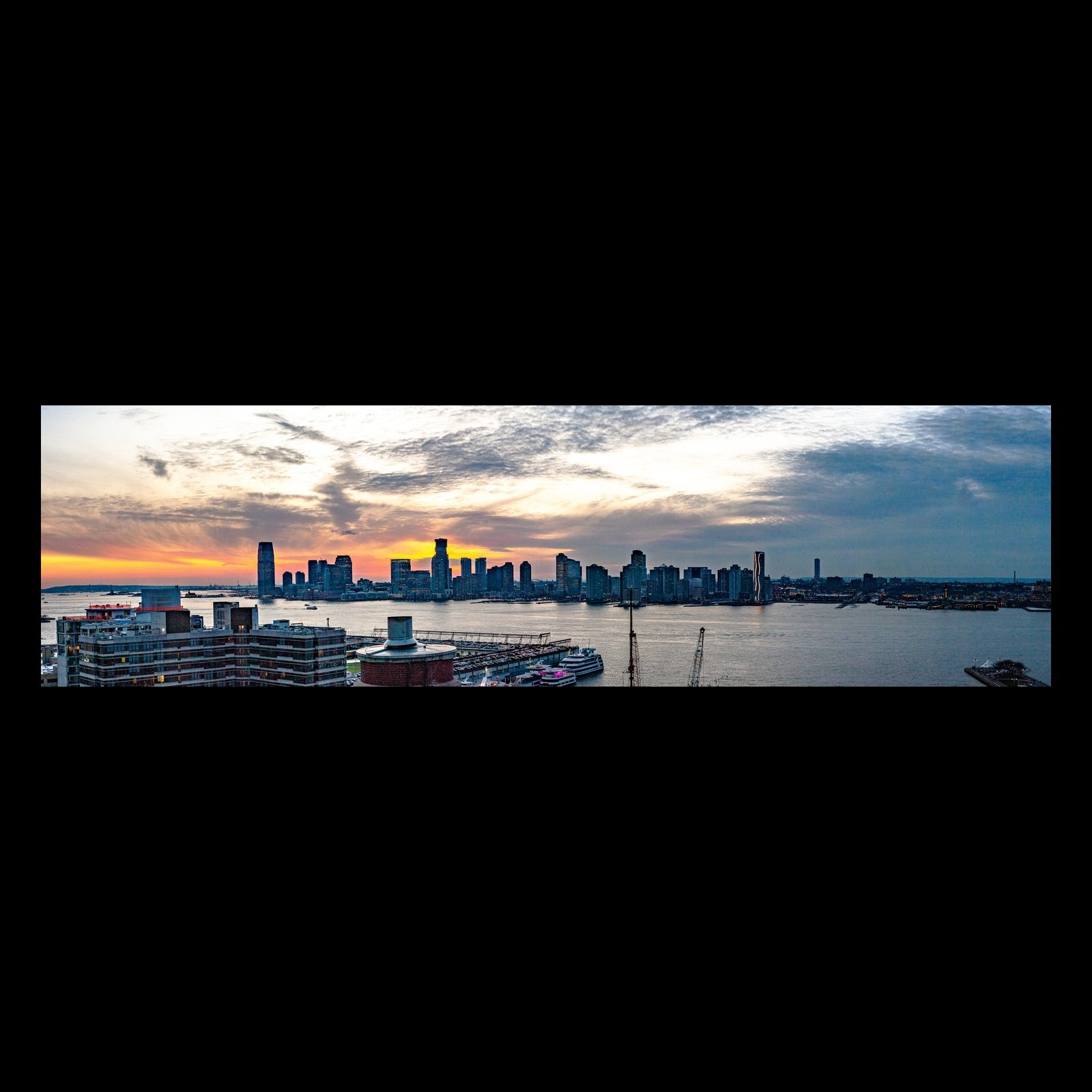 Full-frame black presentation thumbnail of Skyline at Dusk, showing a waterfront skyline darkens beneath a sky shifting from warm sunset to blue evening