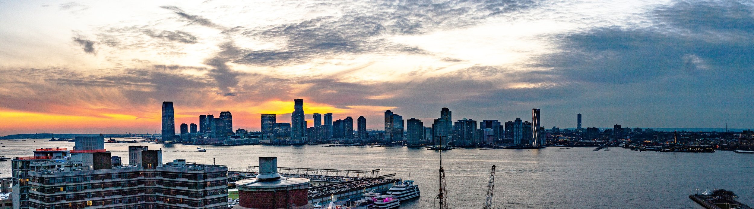 Complete uncropped artwork for Skyline at Dusk, showing a waterfront skyline darkens beneath a sky shifting from warm sunset to blue evening