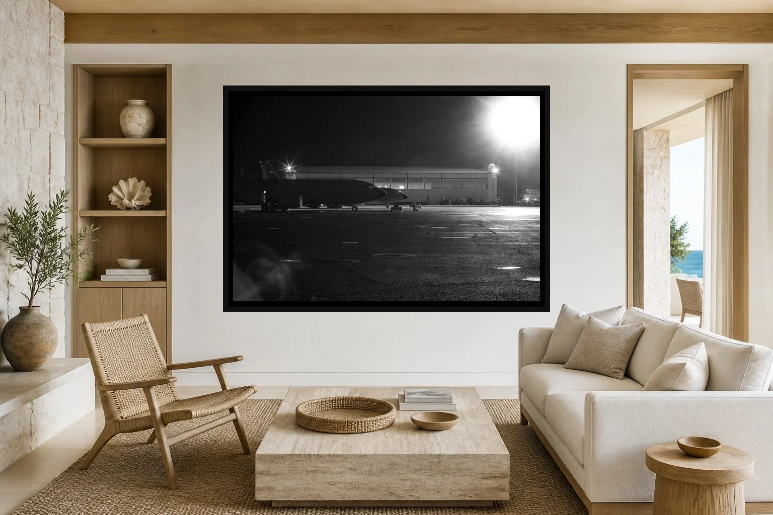 Flightline Noir displayed in a black frame within a restrained coastal residence with pale stone, white oak, woven seating, and a clear central wall