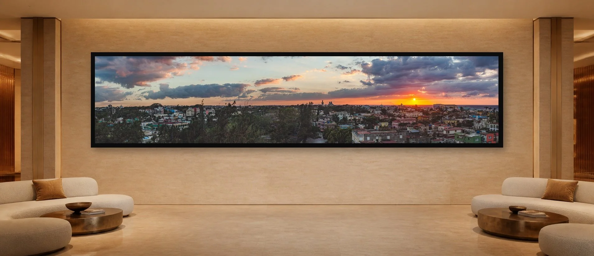 Sunset Over Roofs displayed in a black frame within a five-star hotel corridor lounge with travertine, bronze, sculptural seating, and a clear central wall