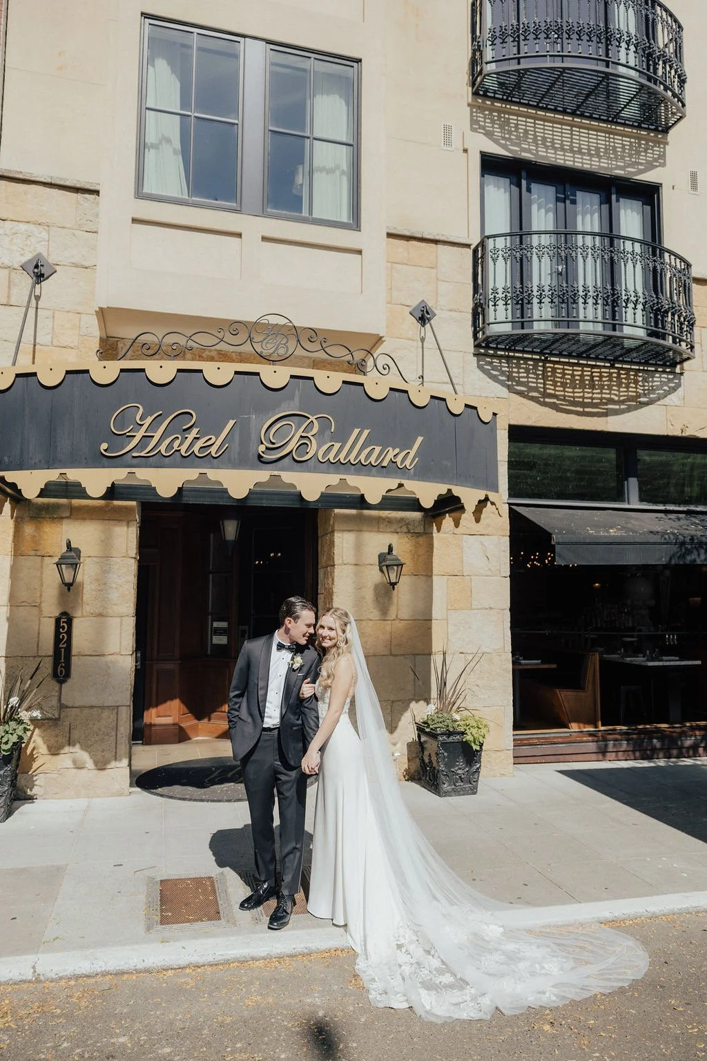 Laurie’s customers, Mariana and Carmen holding hands on a green lawn on their wedding day.