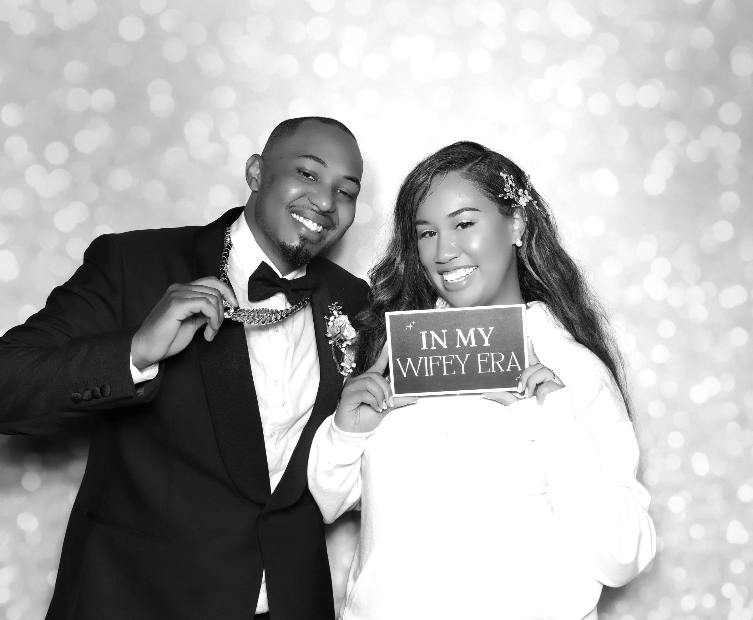 Bride and Groom Posing with a "in my wifey era sign " 