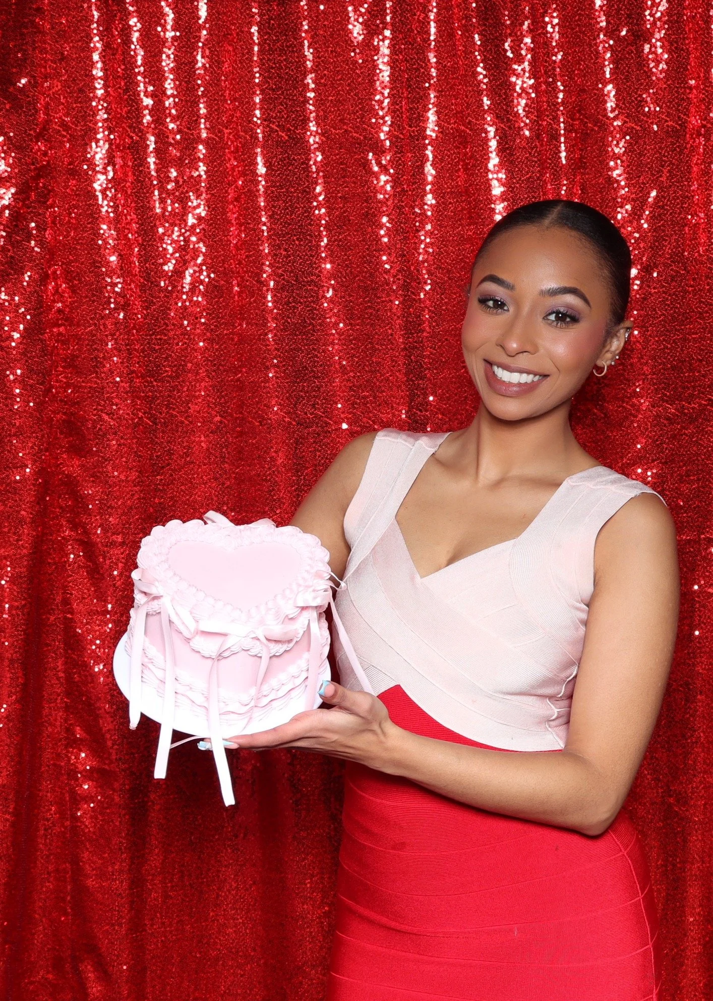 Women Posing with prop birthday cake and smiling