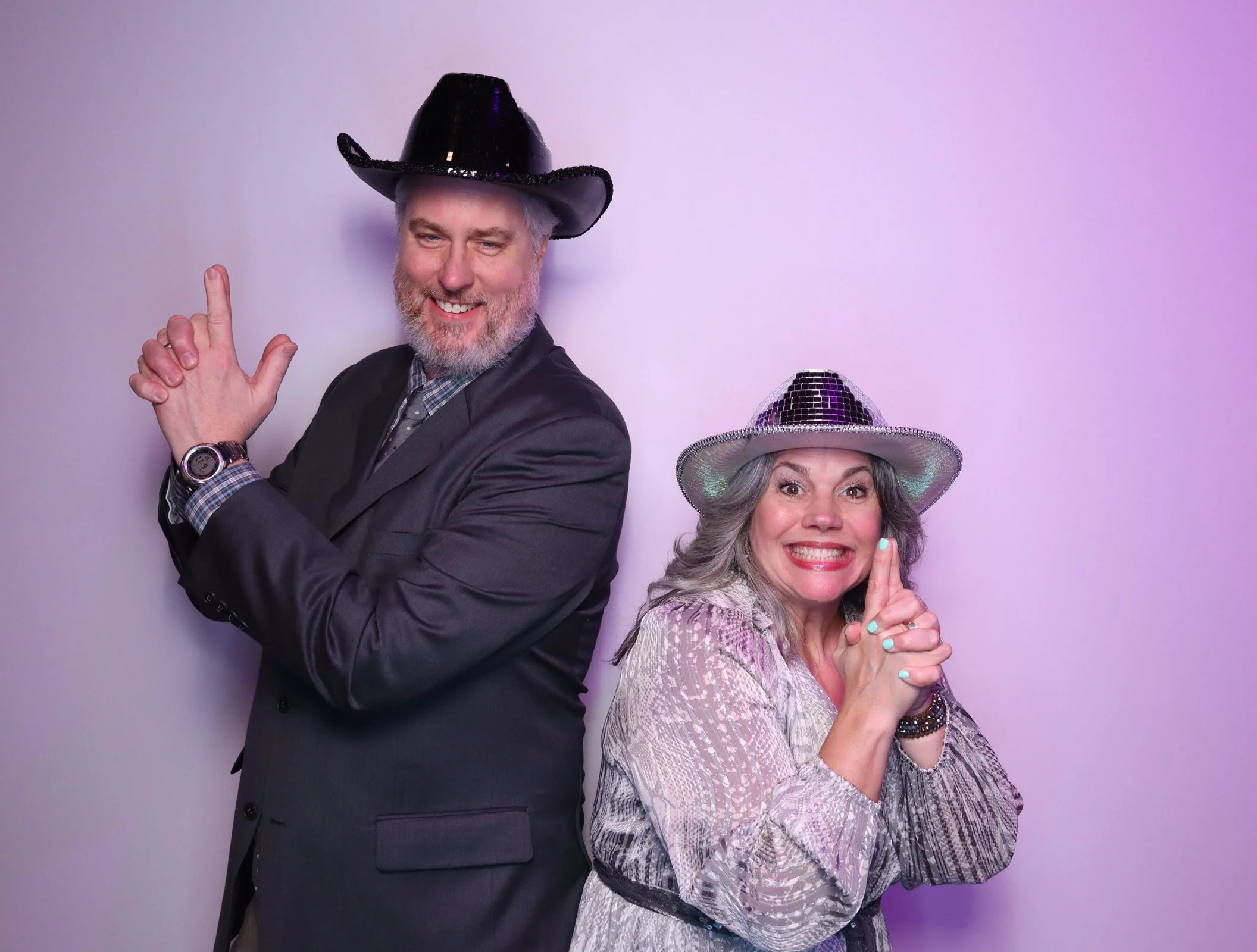 Men and Woman doing the Charlie Angels Pose with party harts 