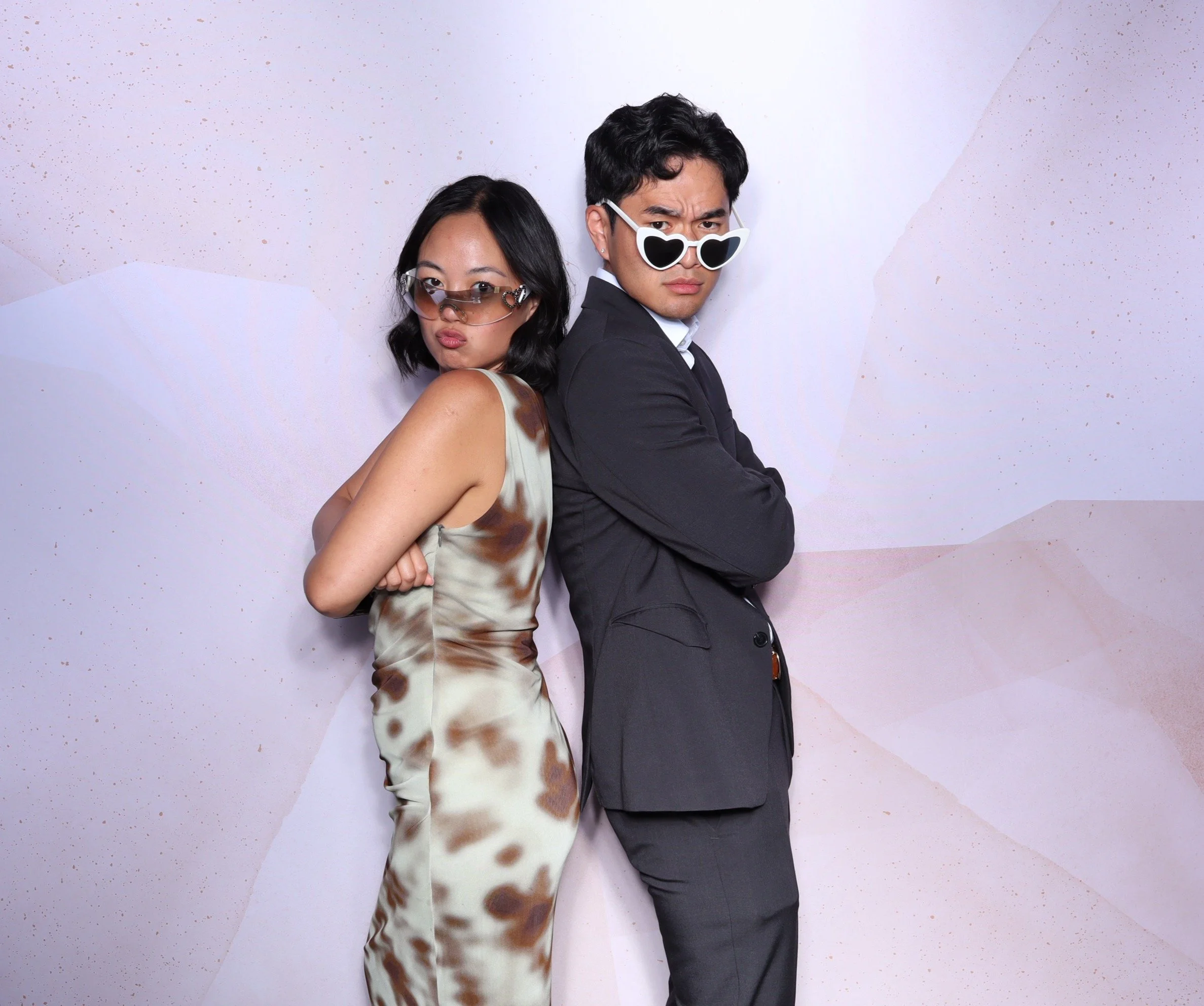 Couple Posing back to back with party glasses