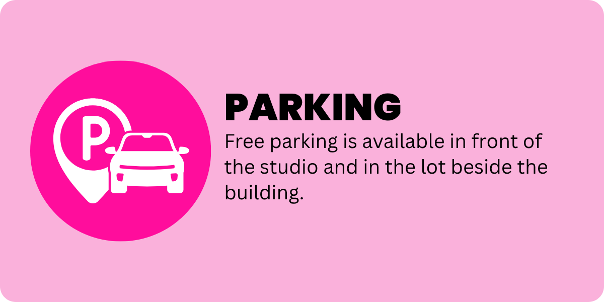Pink sign indicating free parking in front of the studio and lot beside the building.