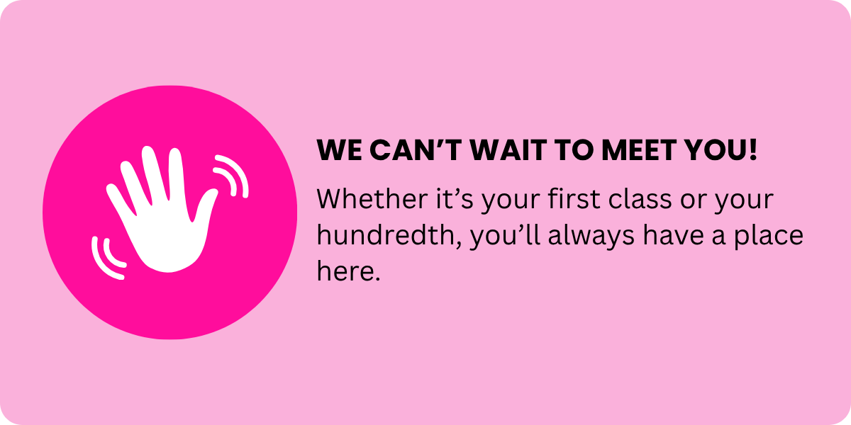 Pink sign with white hand icon and bold black text reading "WE CAN'T WAIT TO MEET YOU!" and smaller black text saying "Whether it's your first class or your hundredth, you'll always have a place here."