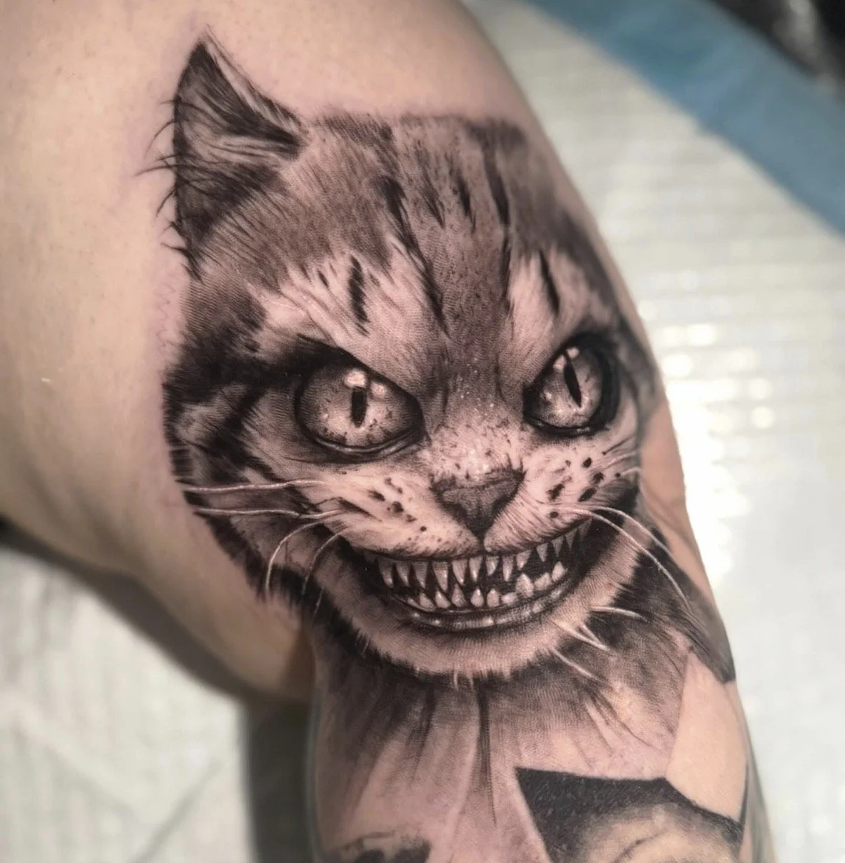Alice in wonderland, cheshire cat tattoo/ Dark and twisted version. Cat portrait style, ultra realistic tattoo.