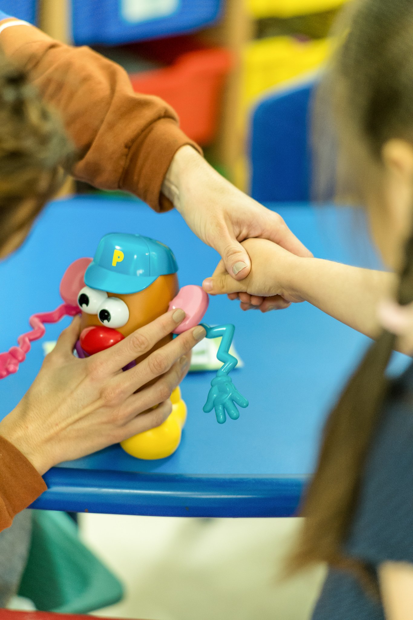 CDC Speech Therapist working learning body parts with a child