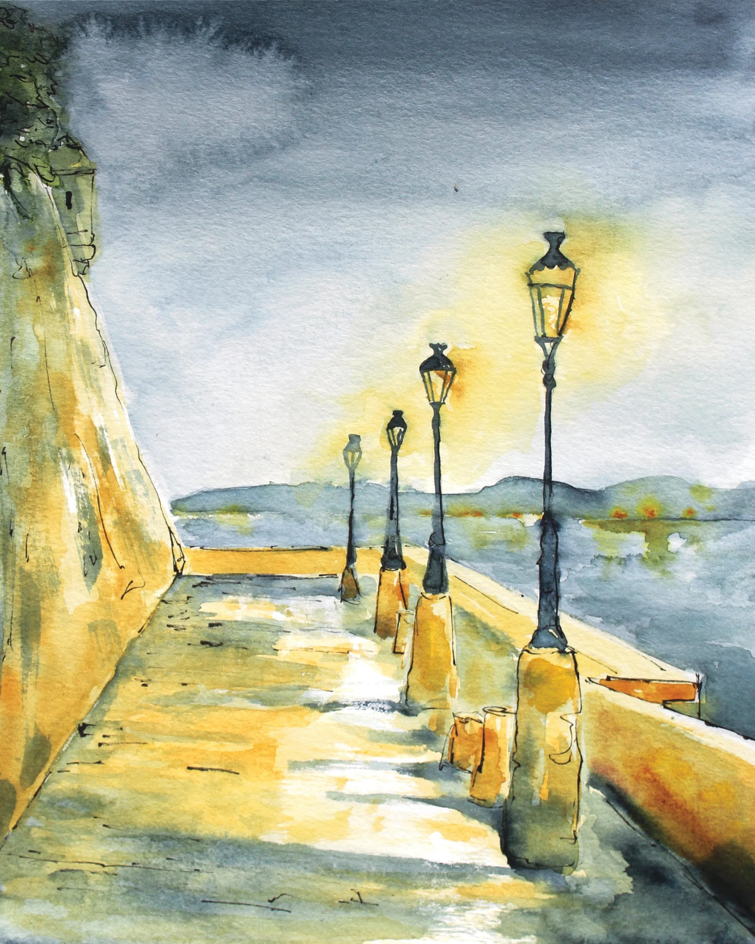 Watercolor painting of a waterfront promenade with a row of vintage street lamps along a stone wall, under a cloudy sky with hills in the distance.