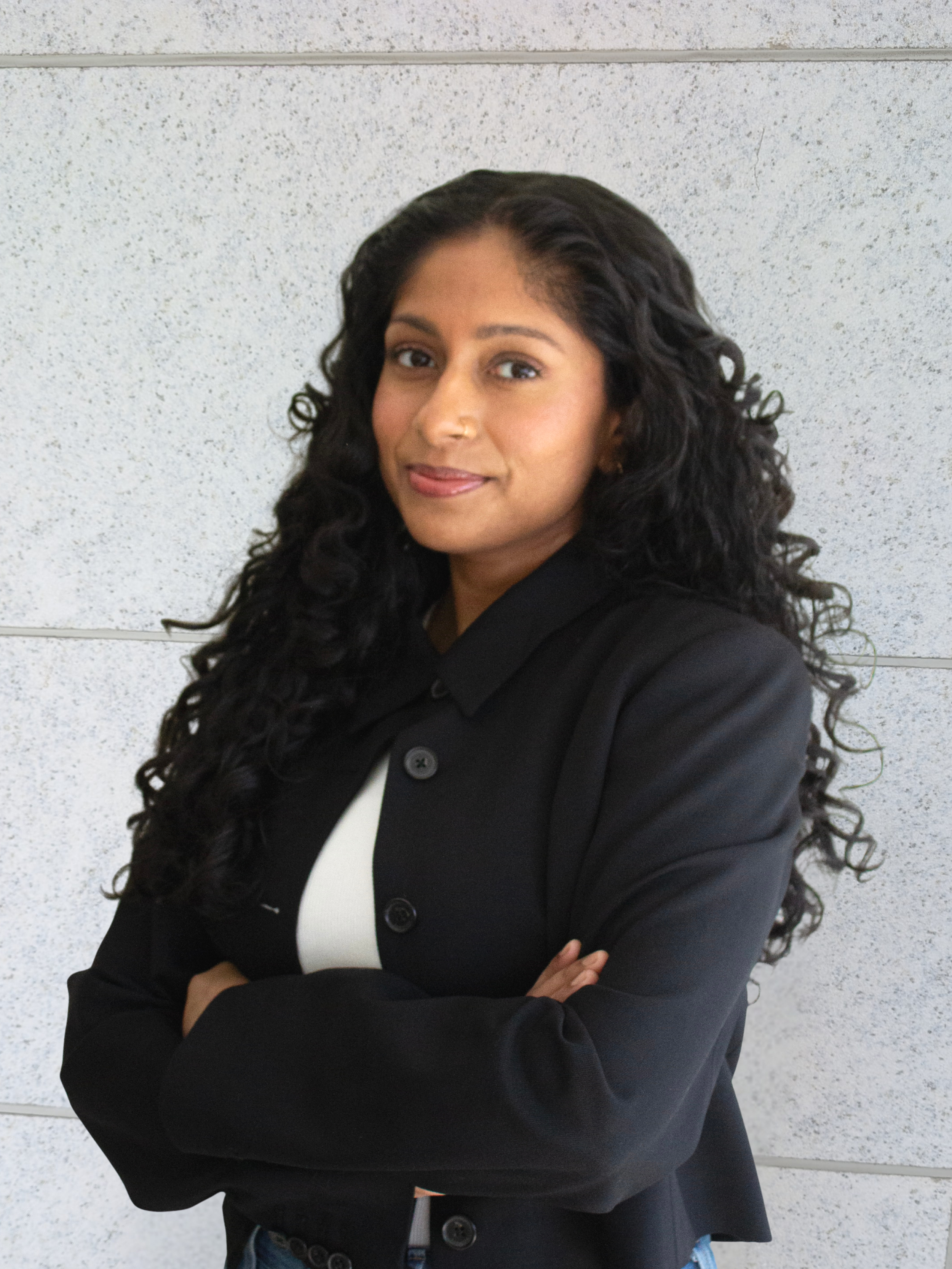 female doctor smiling with arms crossed, doctor of colour