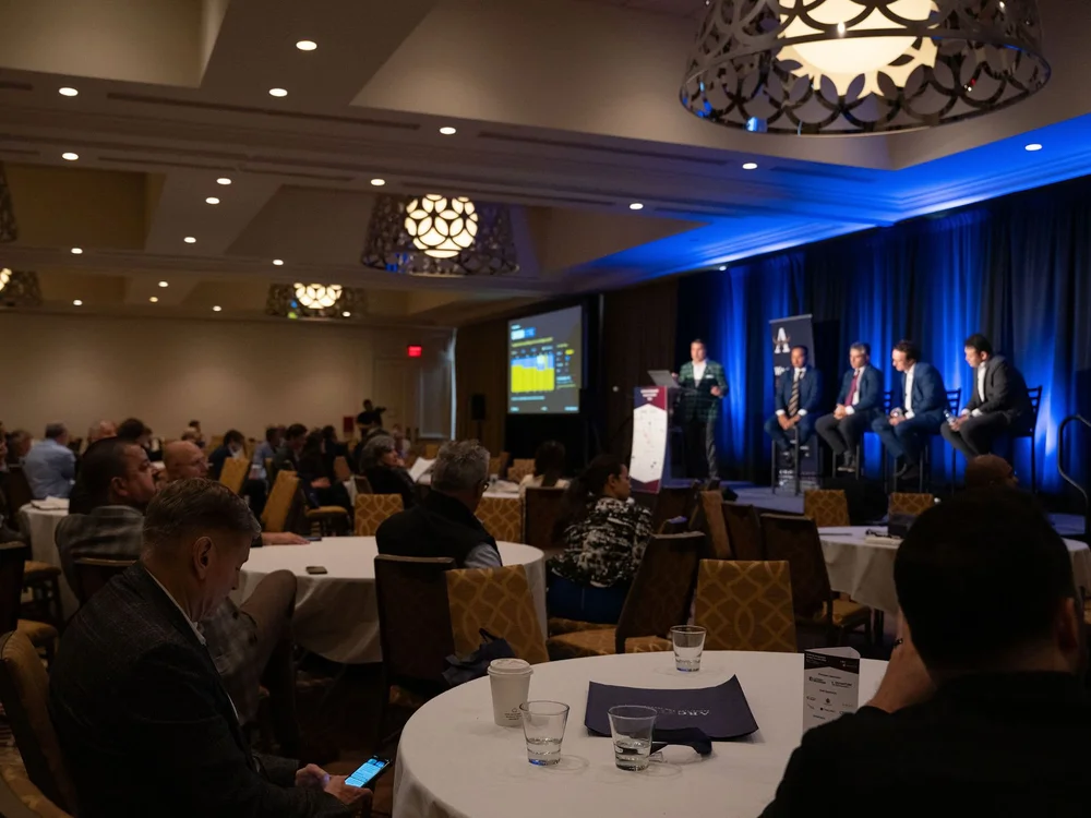 Panel on stage in front of a full room
