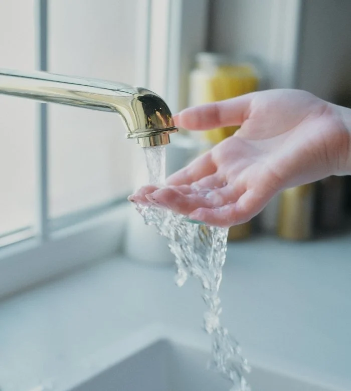 An image of a hand under running tap water.