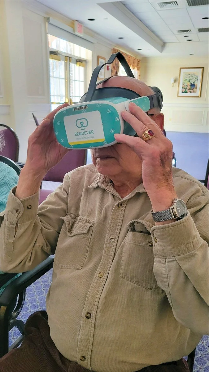 HSM community liaisons help assisted living residents travel the world by way of a VR headset.