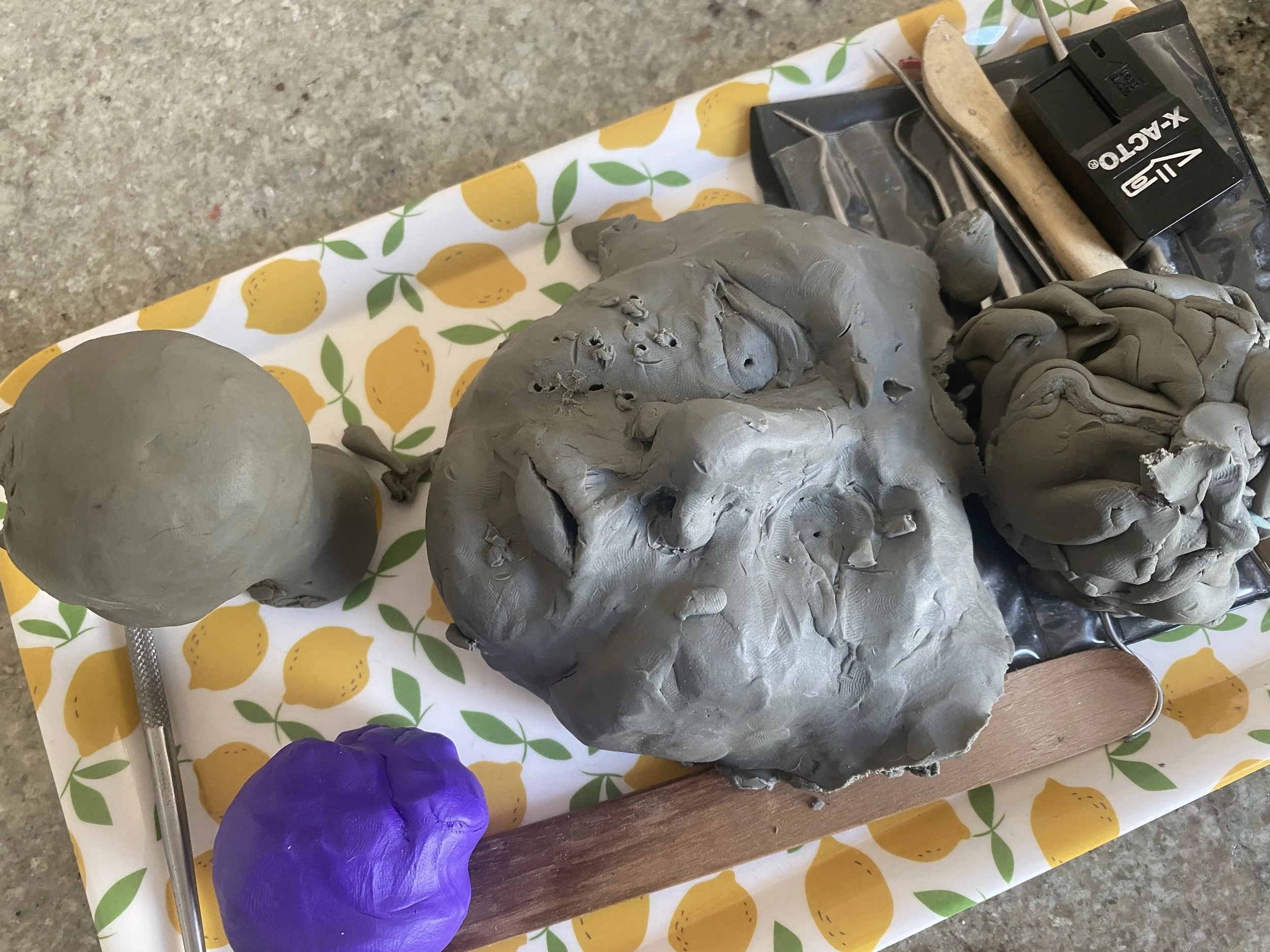 September 11, 2023 - The state of the giant head experiment.  He's become a convenient place to snag extra clay and wipe excess clay from my tools.  I'm learning to love him.  