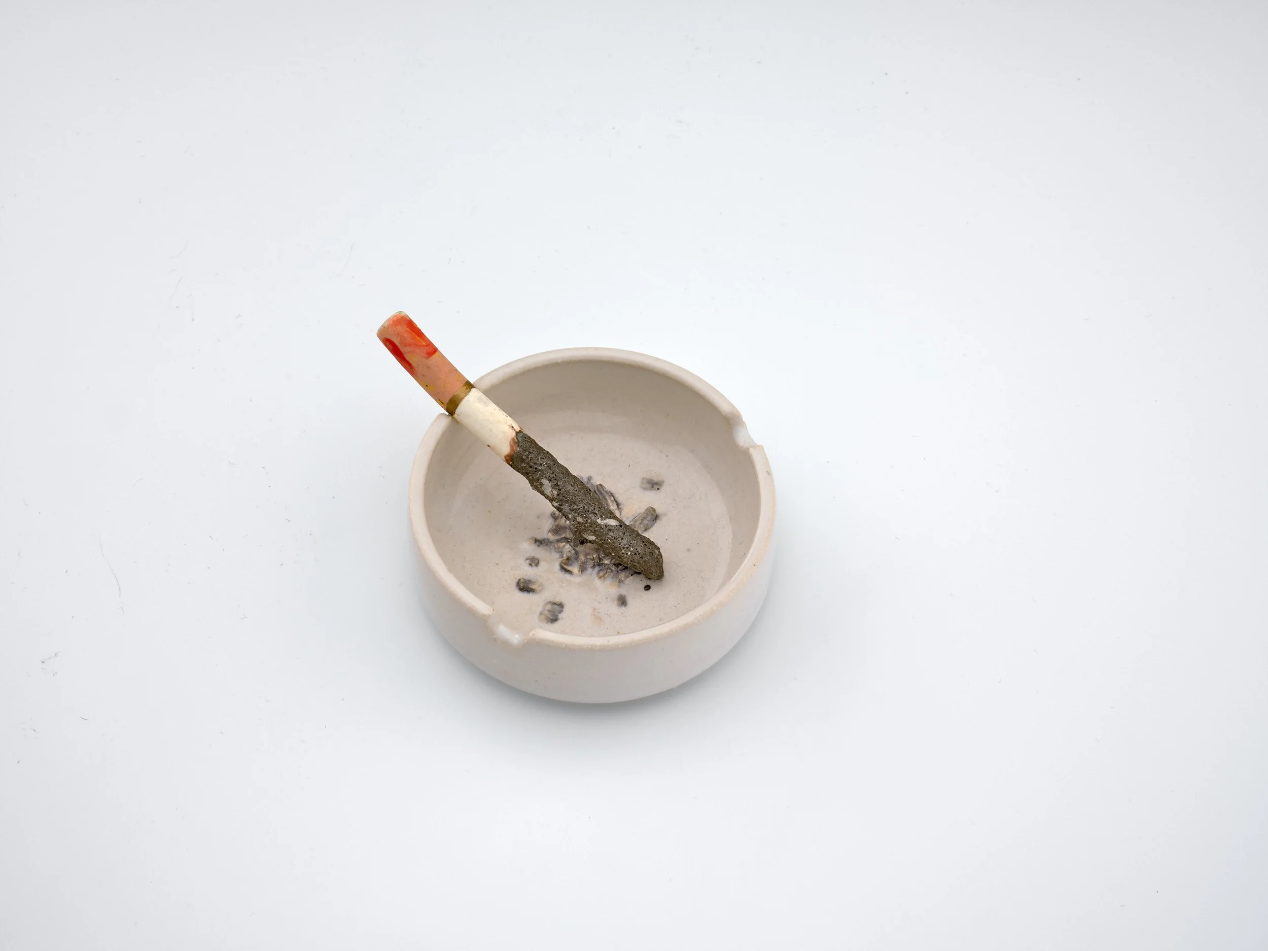 Erica Eyres. Ashtray With Cigarette (long ash), 2024. Glazed stoneware. life size.  Courtesy of the Artist & Norberg Hall.
