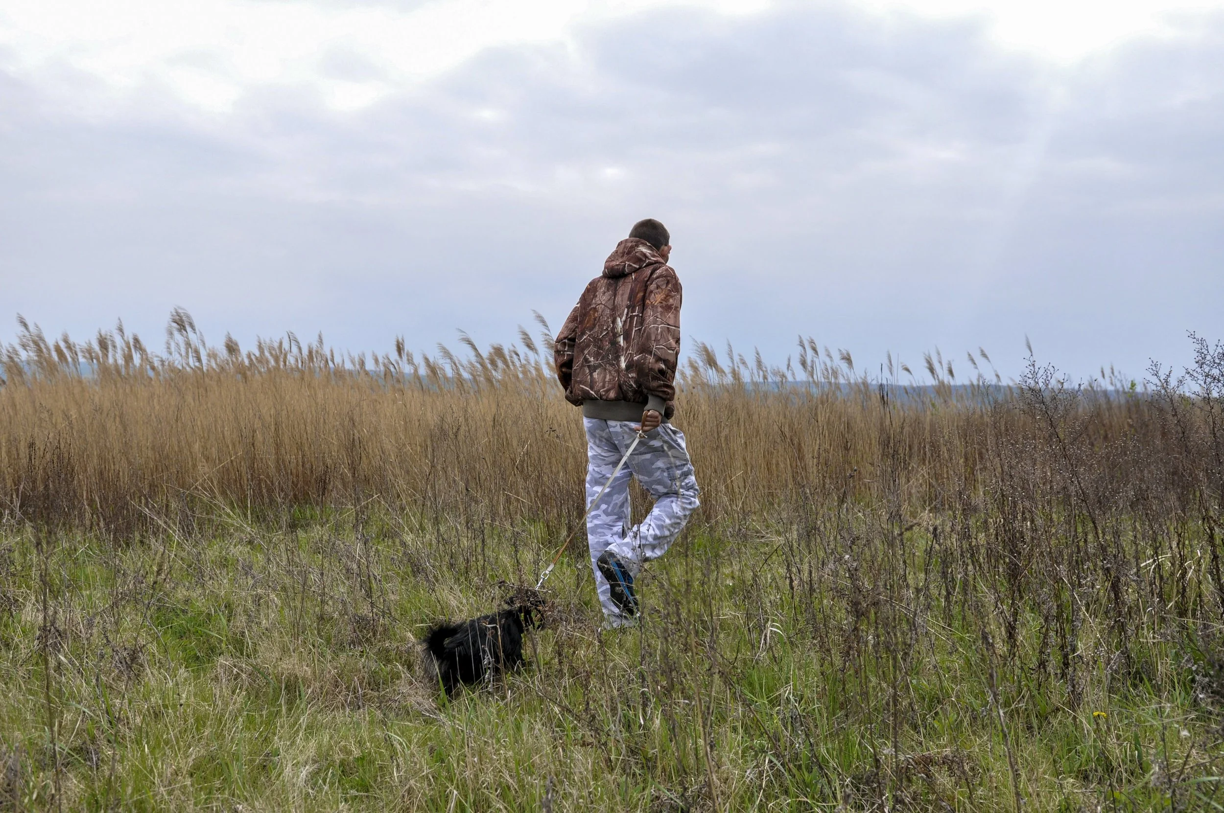 Gábor walks his dog after the end of his work shift in the village border. 