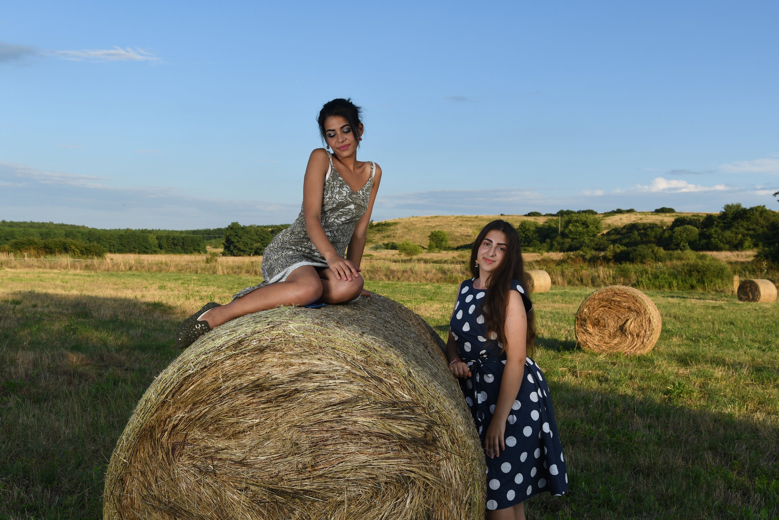 Evelin and her friend Bianka pose for their new profile picture in the hay bales between Drégelypalánk and Ipolyvece.