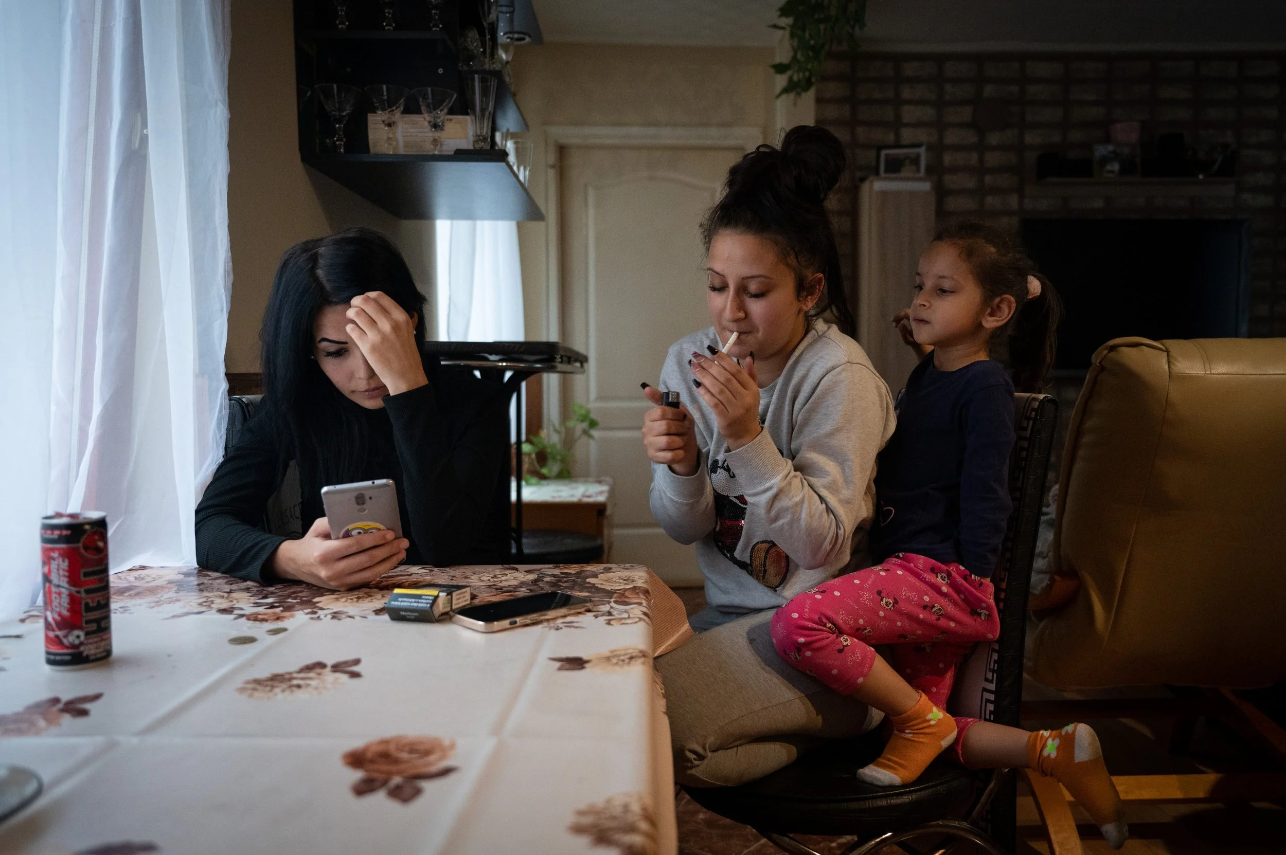  Evelin Kovács and her new in-law rolls a cigarette in their home in Recsk, Northern Hungary. 