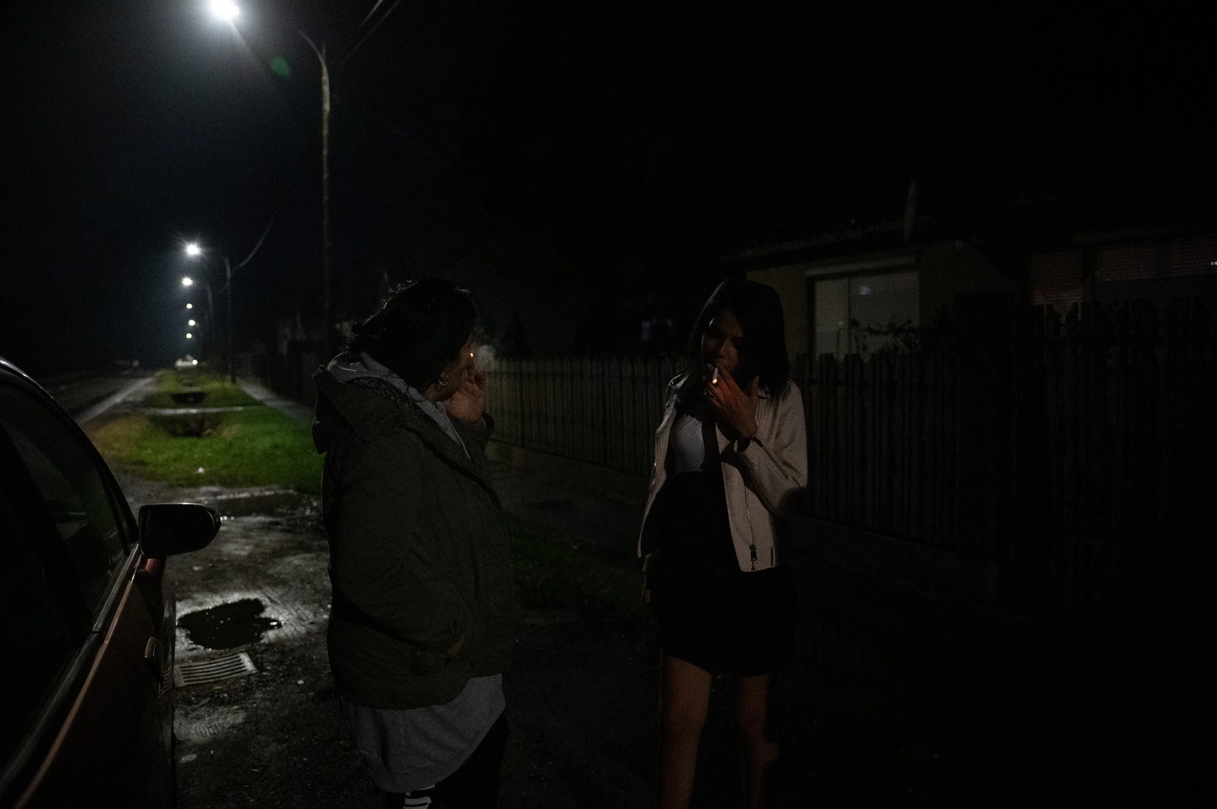  Evelin is having a cigarette with her mother in front of their house 3 days before the birth of her daughter, Scarlett, on 30 November 2022. 