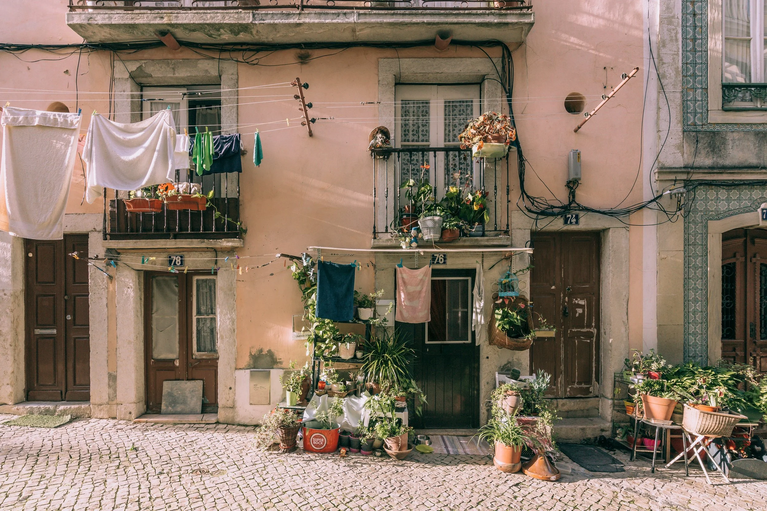 Charming European housefront with potted plants and hanging laundry