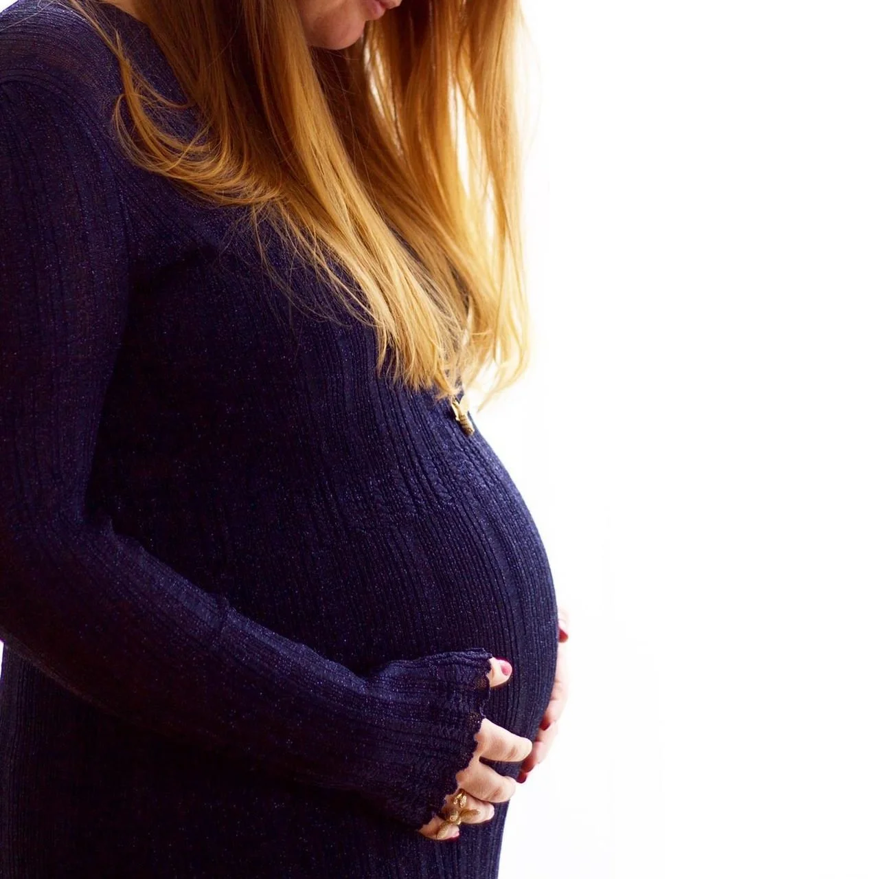 Pregnant woman holding her bump