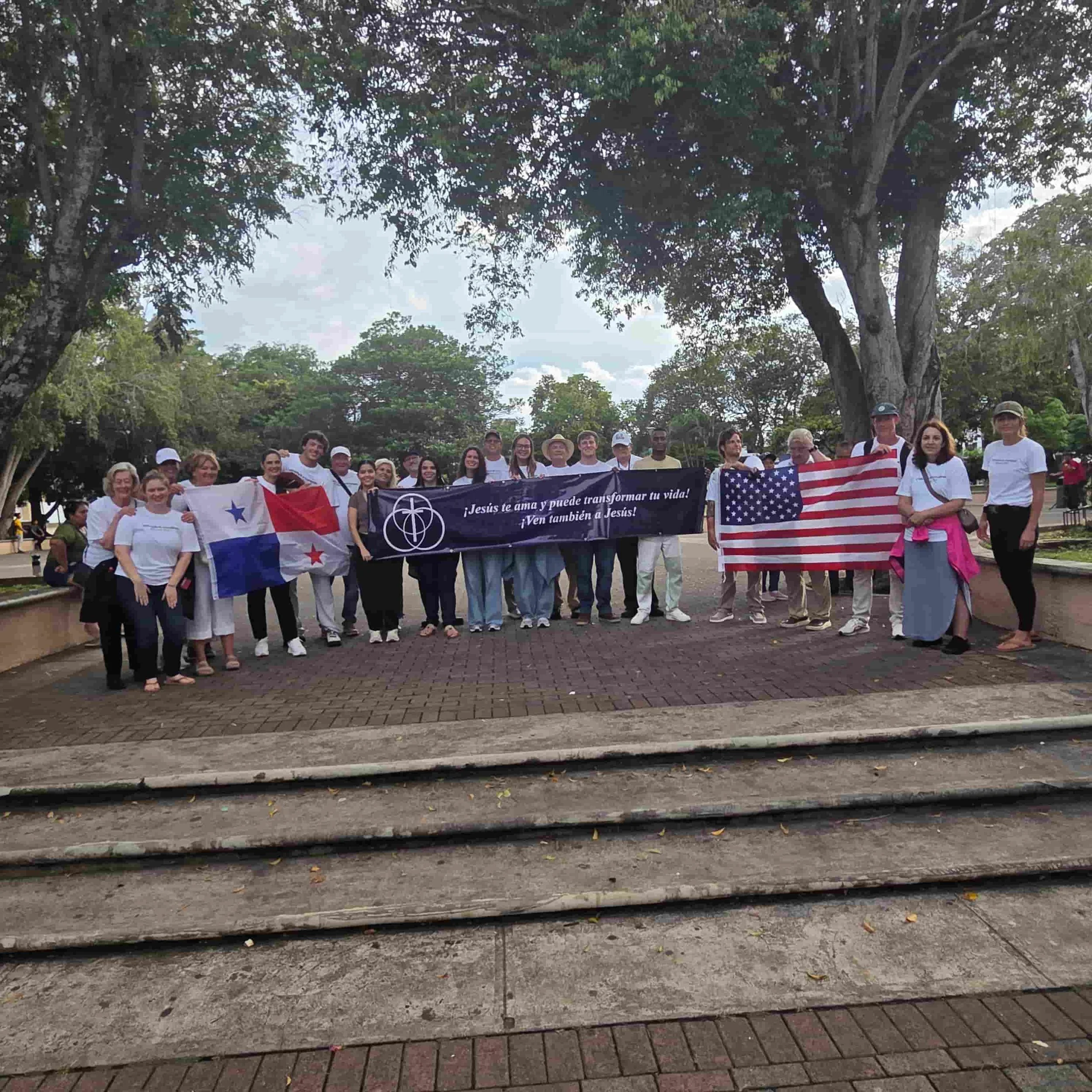 Rick Bonfim Ministries mission team gathered with ministry partners in Panama while holding Panamanian and American flags.