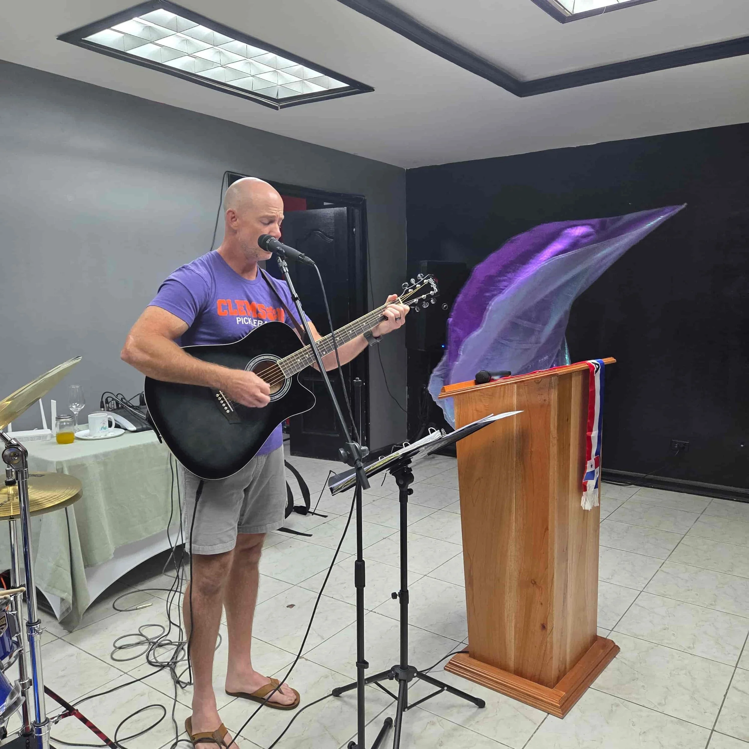 Mission team member leading worship with an acoustic guitar during the Rick Bonfim Ministries mission trip to Panama.