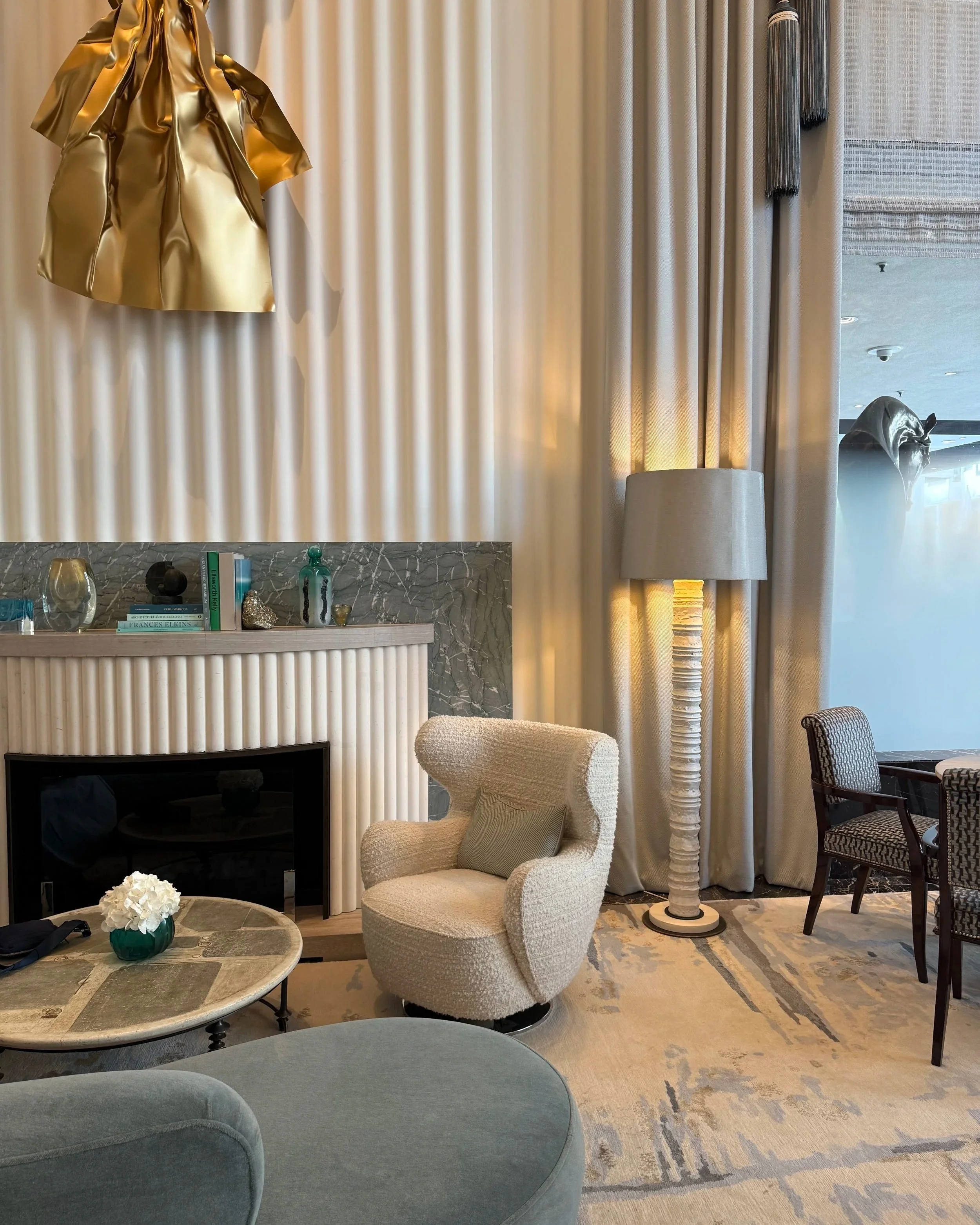 Calm contemporary hotel interior with natural light, clean lines, and a restrained, neutral palette.