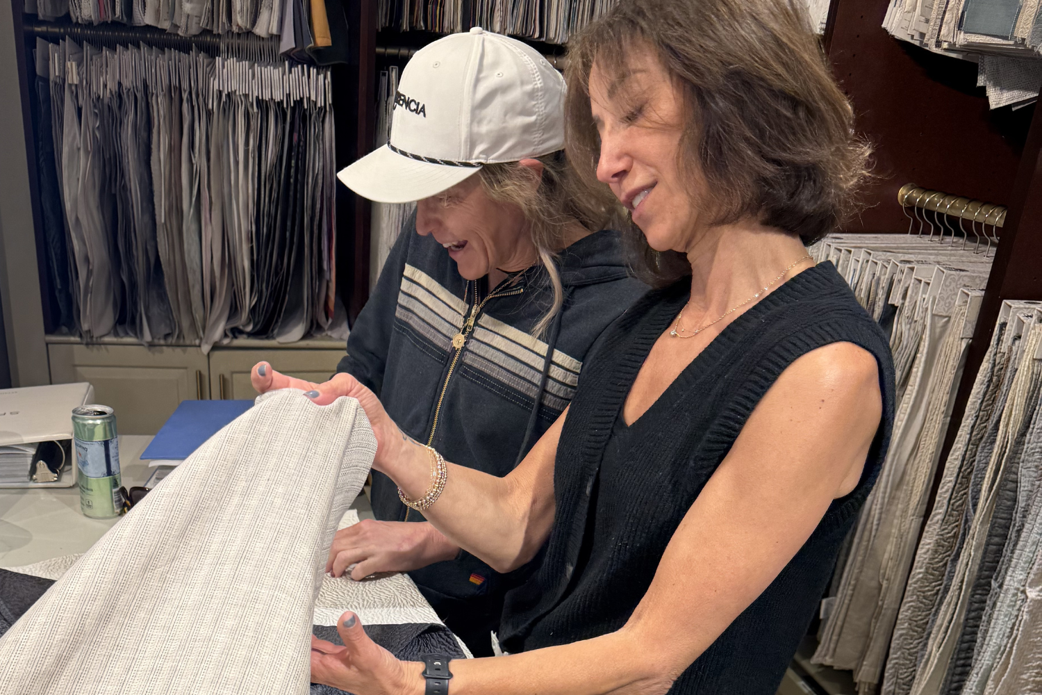 Reviewing fabric samples at The Brass Bed in Denver to refine materials and create a cohesive interior design palette