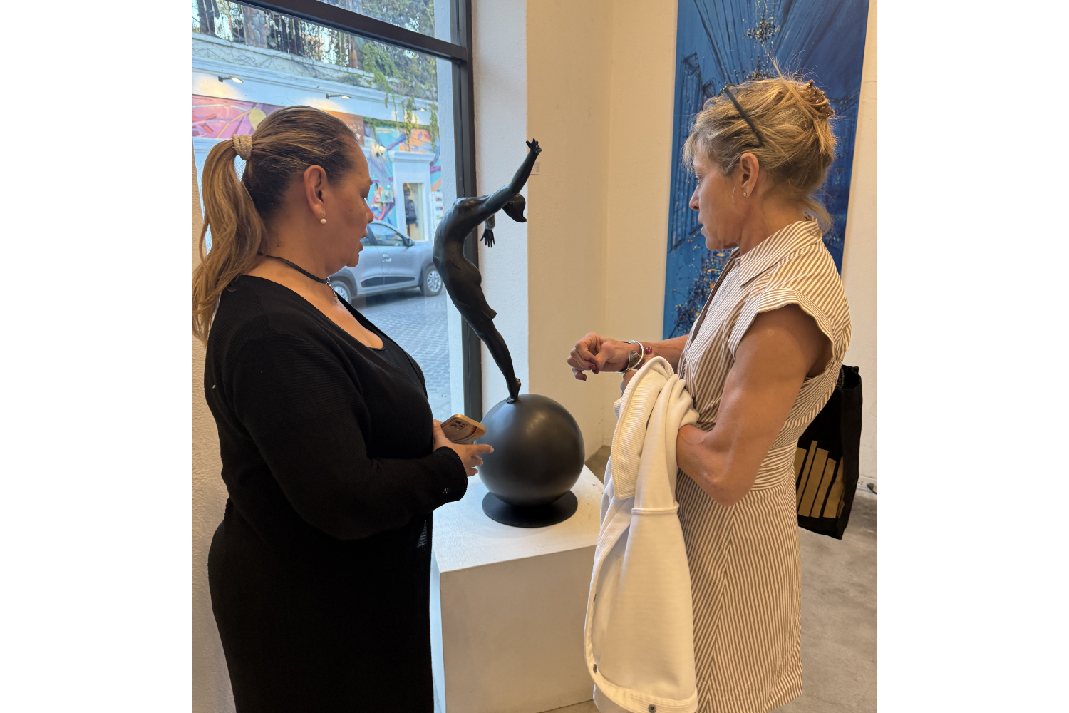 Selecting artwork in a gallery as part of the interior design process to create a more personal and collected space