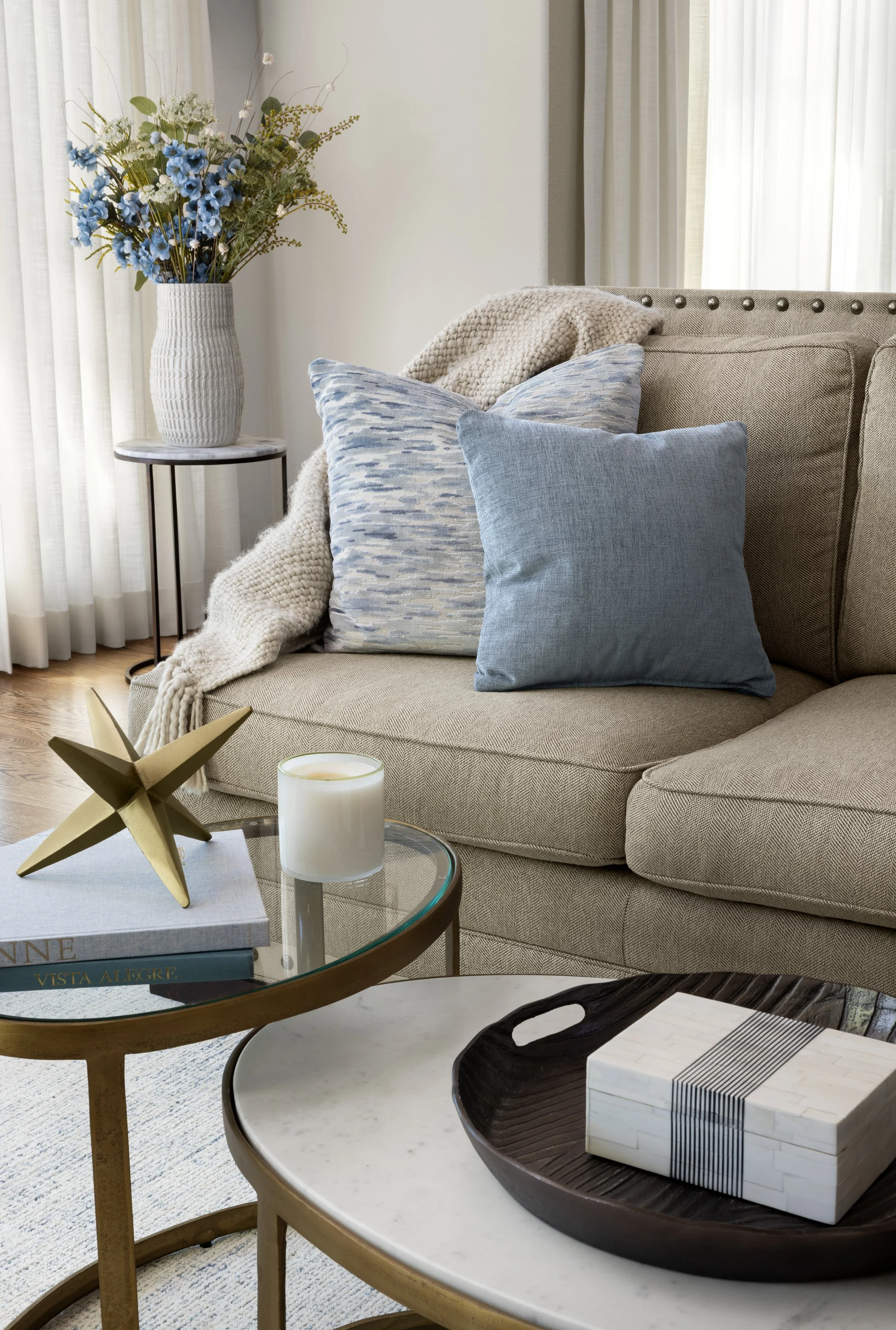Detail of layered textiles including custom pillows, drapery and upholstery in a soft, complementary palette.