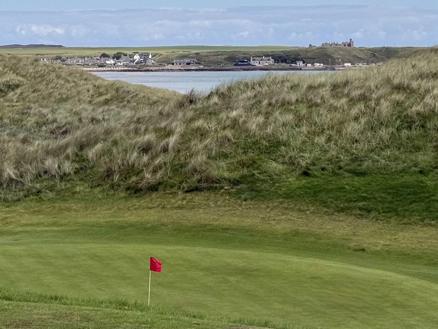 Cruden Bay Golf Club with the village of Port Erroll and Slains Castle in the distance.