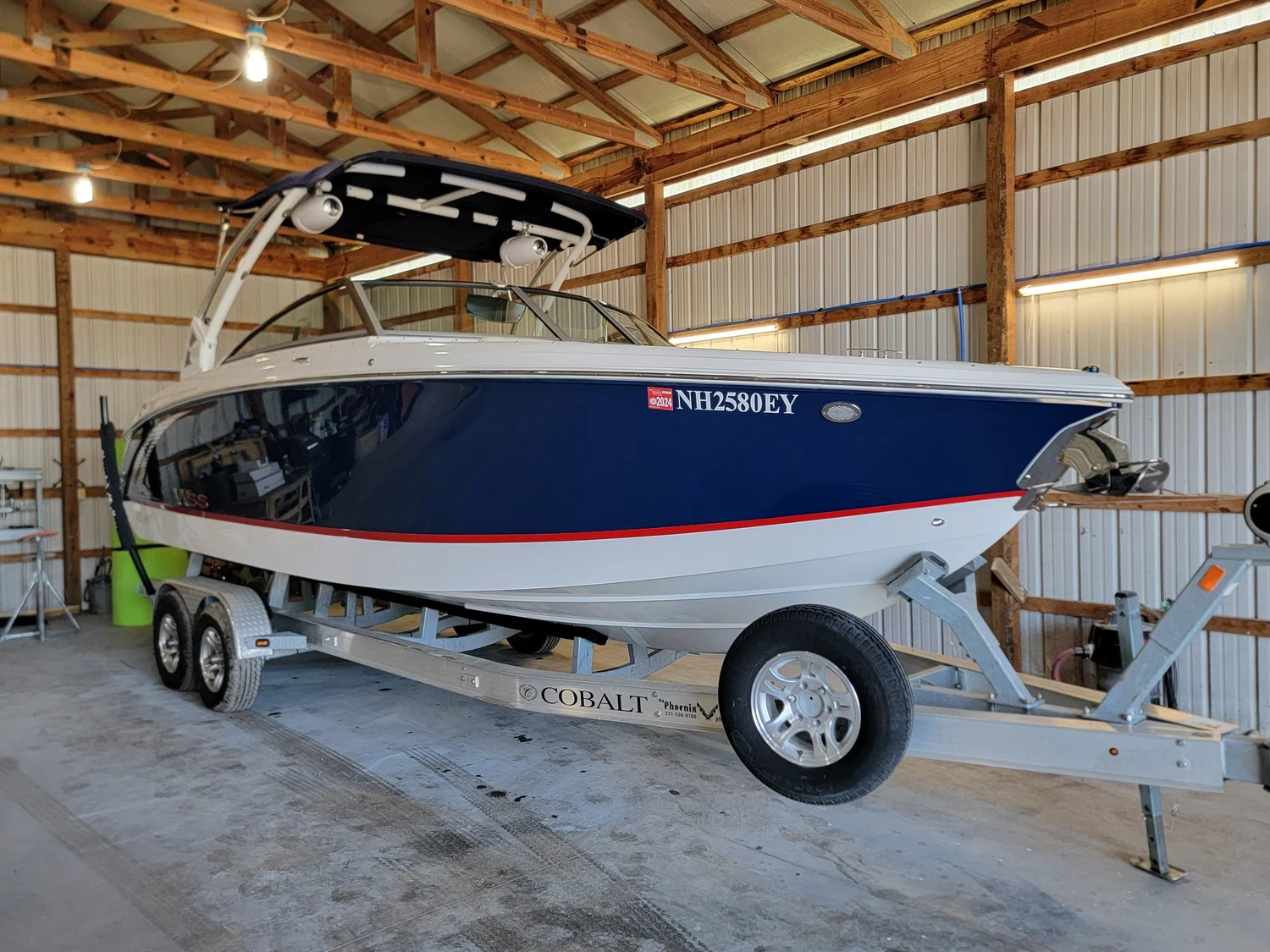 Runabout on a trailer inside the shop