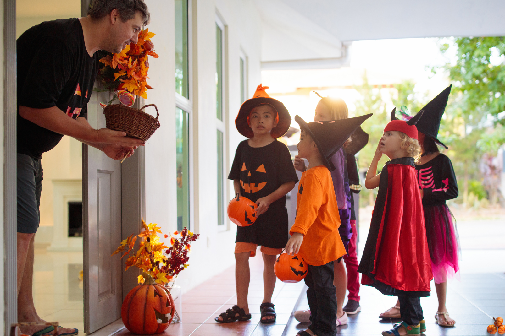 Young kids at a house trick-or-treating