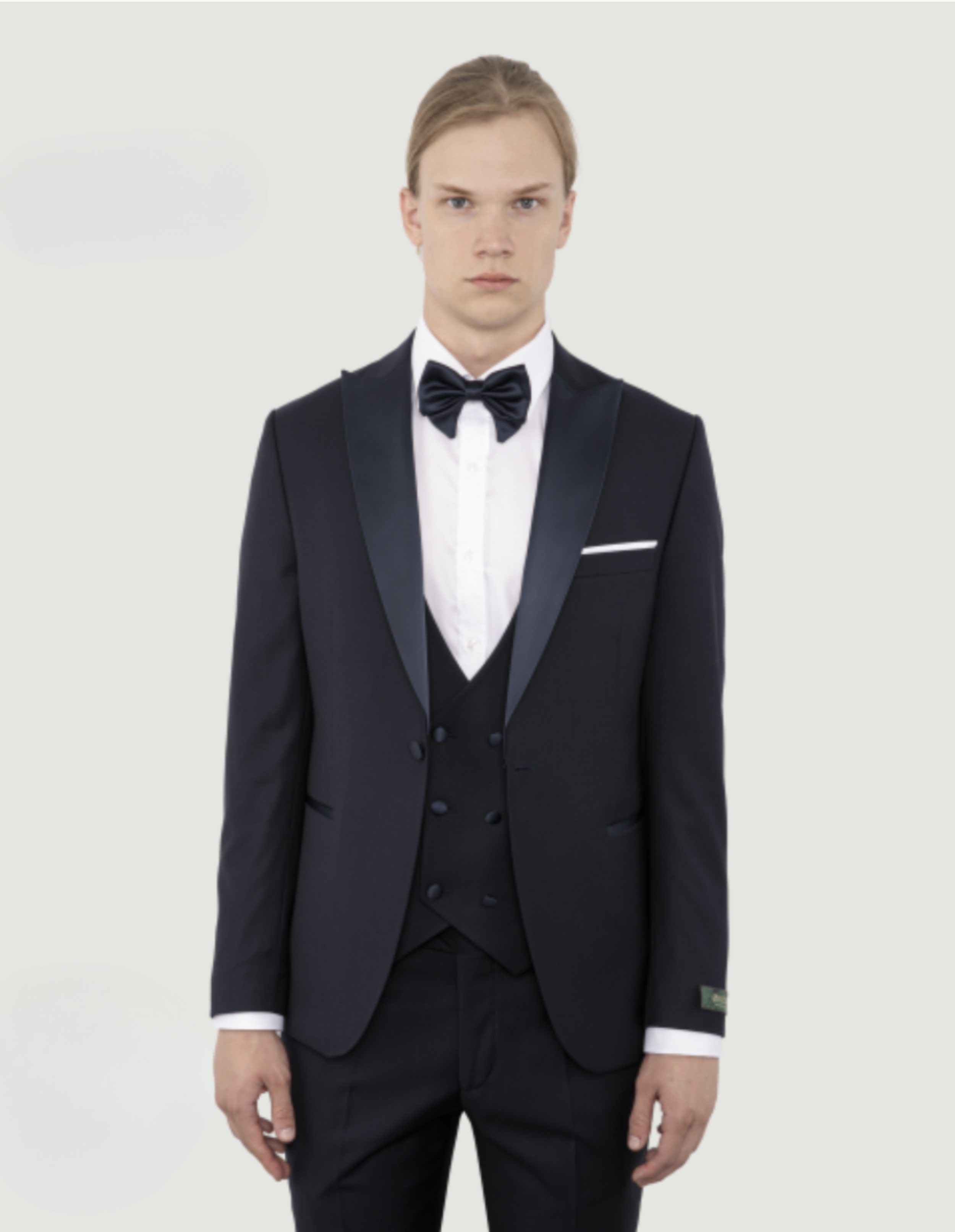 A  black tuxedo with a white dress shirt and a black bow tie.