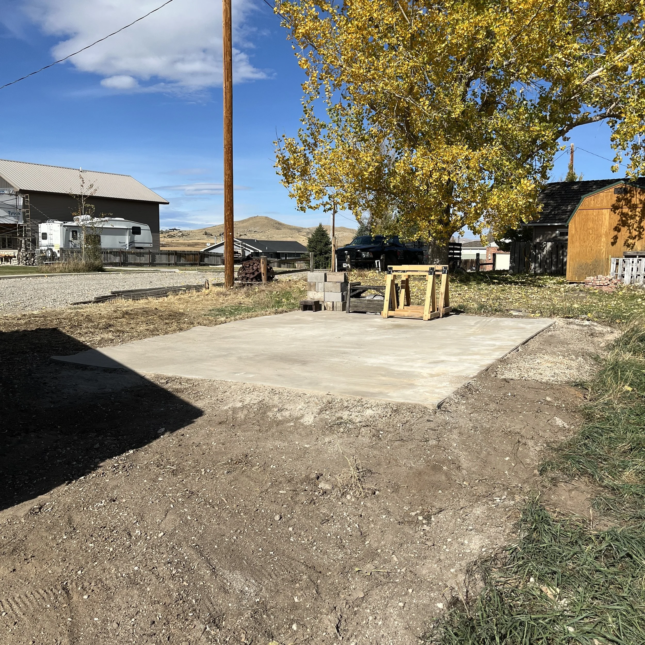 Old barn site with clean concrete pad after being demolished in Cody, WY