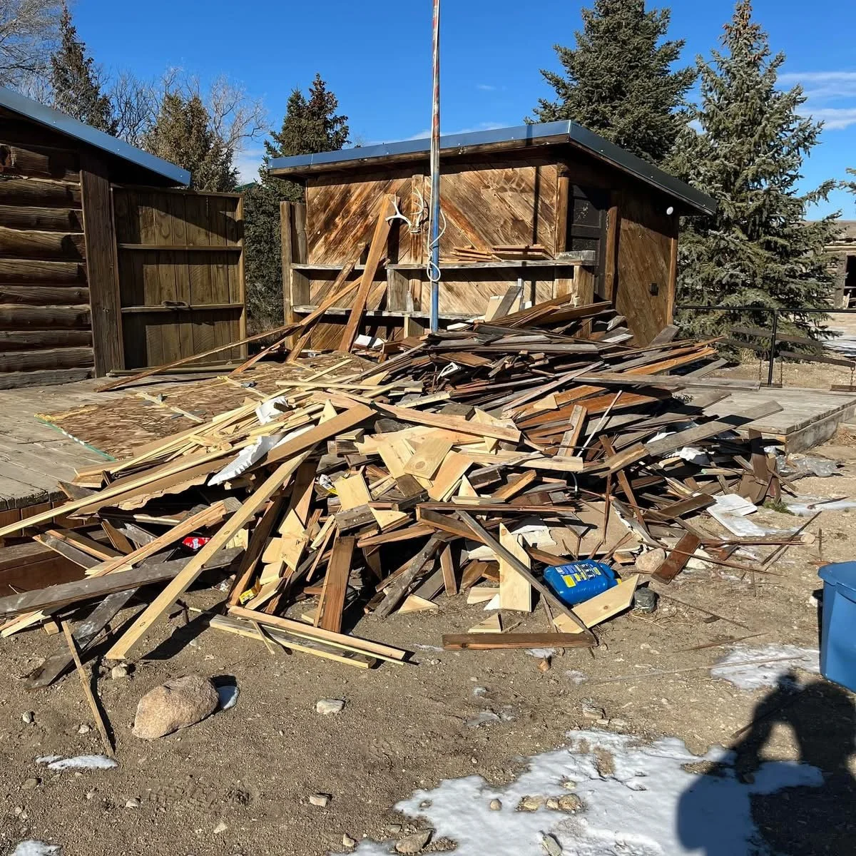 Pile of construction debris getting loaded into a trailer in Cody, WY