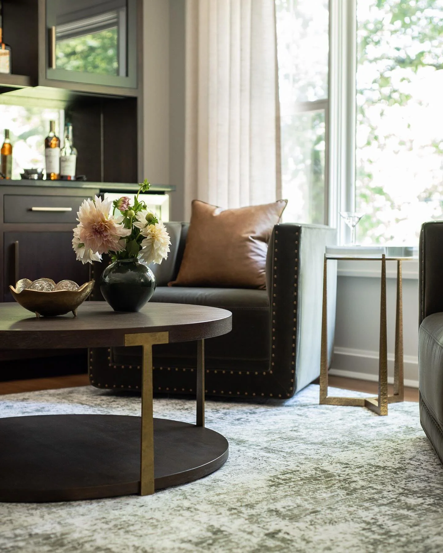 A lounge designed for slow evenings and good conversation.  Tailored leather pillows, warm brass accents, and touches of olive create a space that feels equal parts sophisticated and inviting.

Interior Design: @kr_interior_design_studio 
Photography