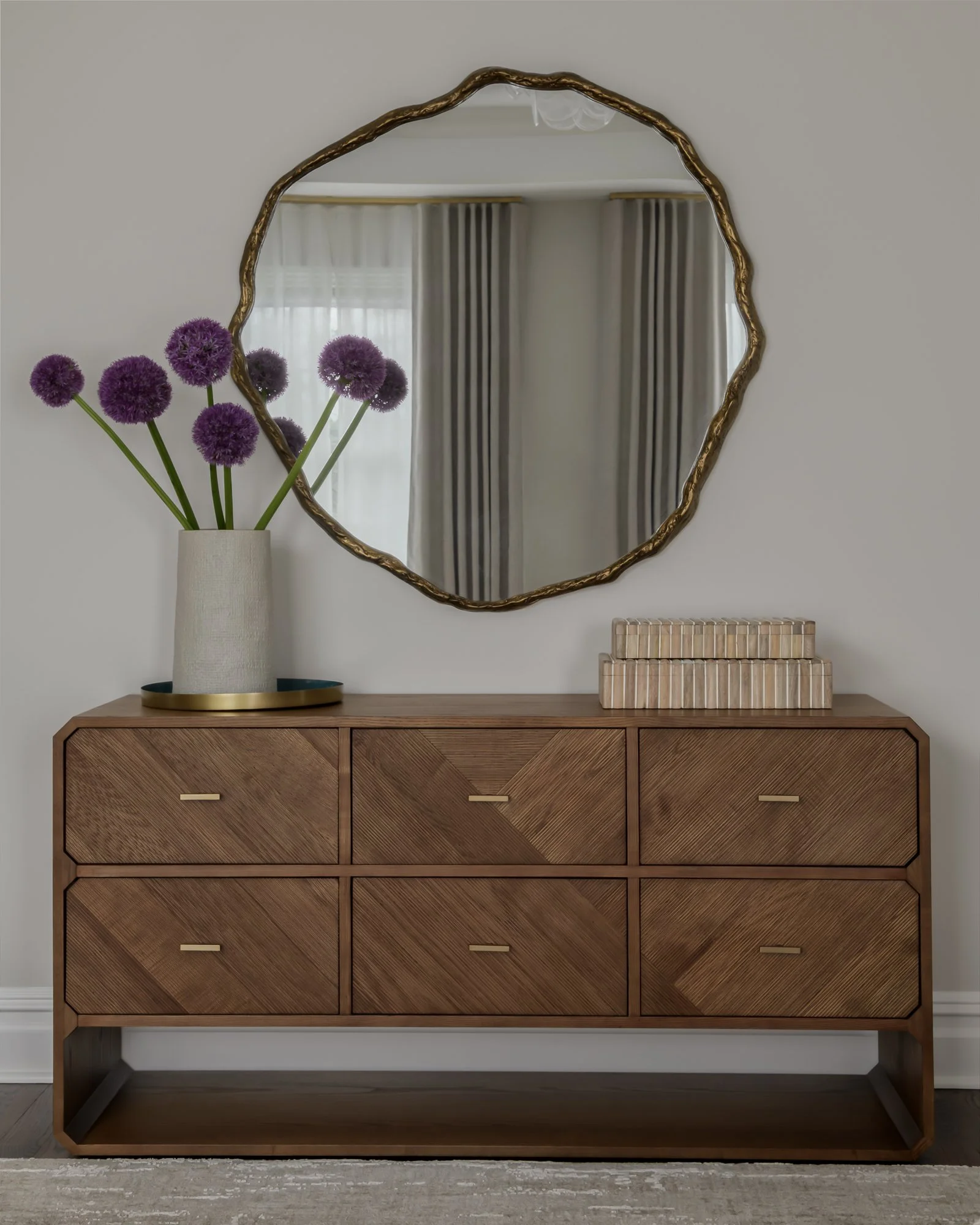 round-brass-mirror-over-wood-dresser.jpg